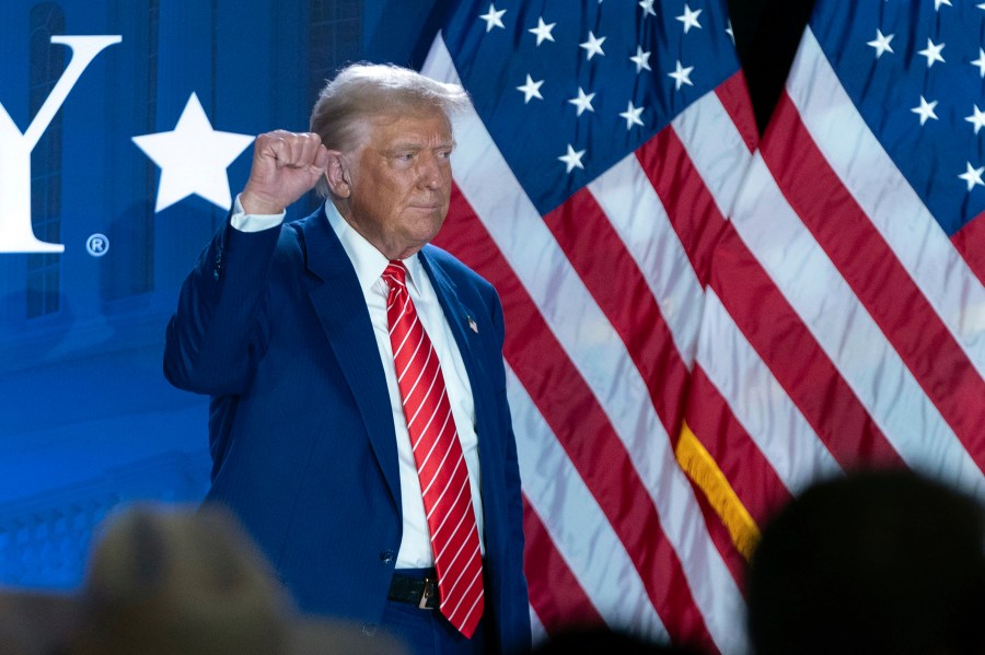 Republican presidential nominee former President Donald Trump gestures as he leaves after speaking with Moms for Liberty co-founder Tiffany Justice during an event at the group's annual convention in Washington, Friday, Aug. 30, 2024. (AP Photo/Jose Luis Magana)