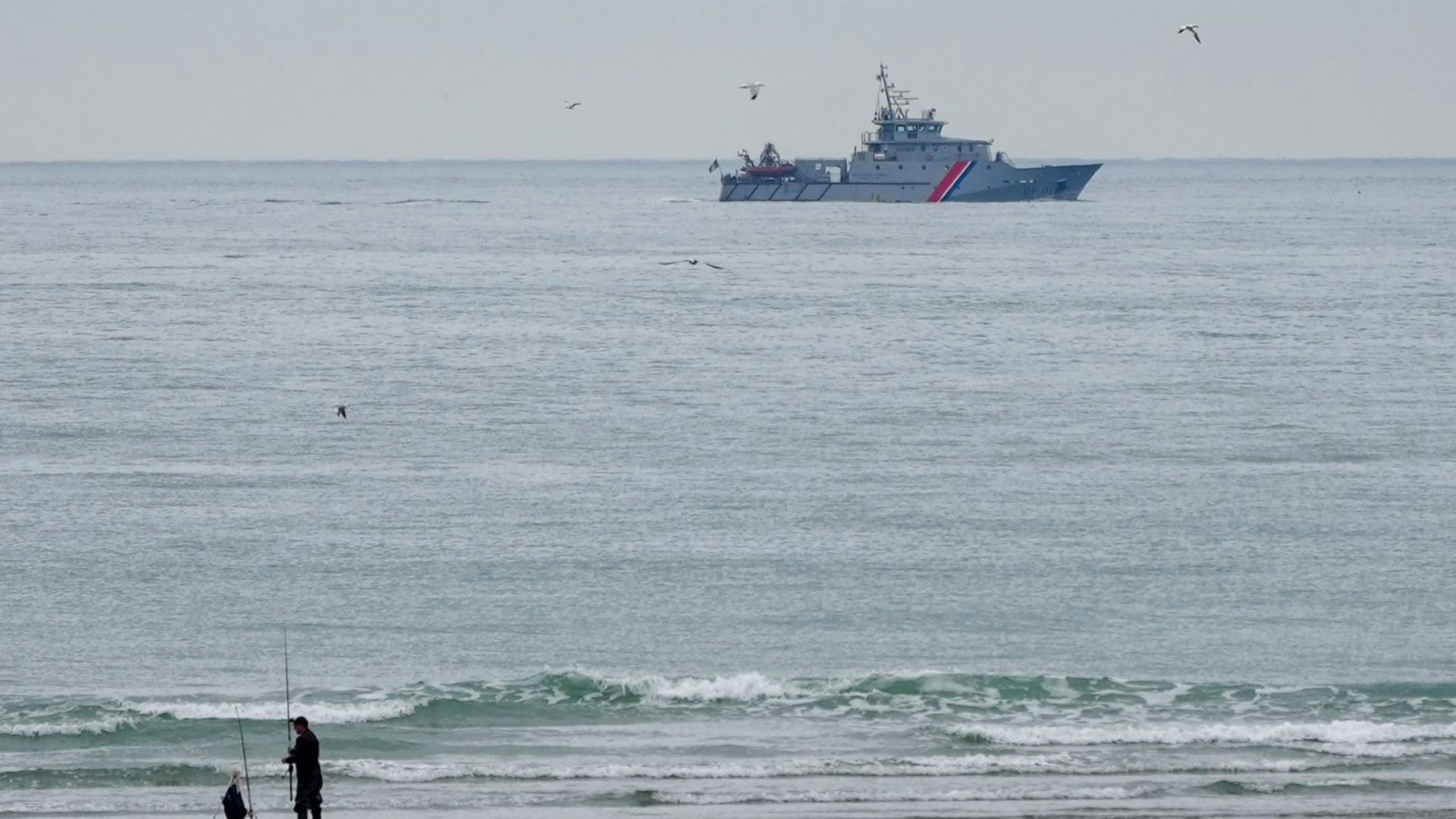 A vessel of the French Gendarmerie Nationale patrols in front of the Wimereux beach, France, Wednesday, Sept. 4, 2024. A boat carrying migrants ripped apart in the English Channel as they attempted to reach Britain from northern France on Tuesday, plunging dozens into the treacherous waterway and leaving 12 dead, authorities said. (AP Photo/Nicolas Garriga)