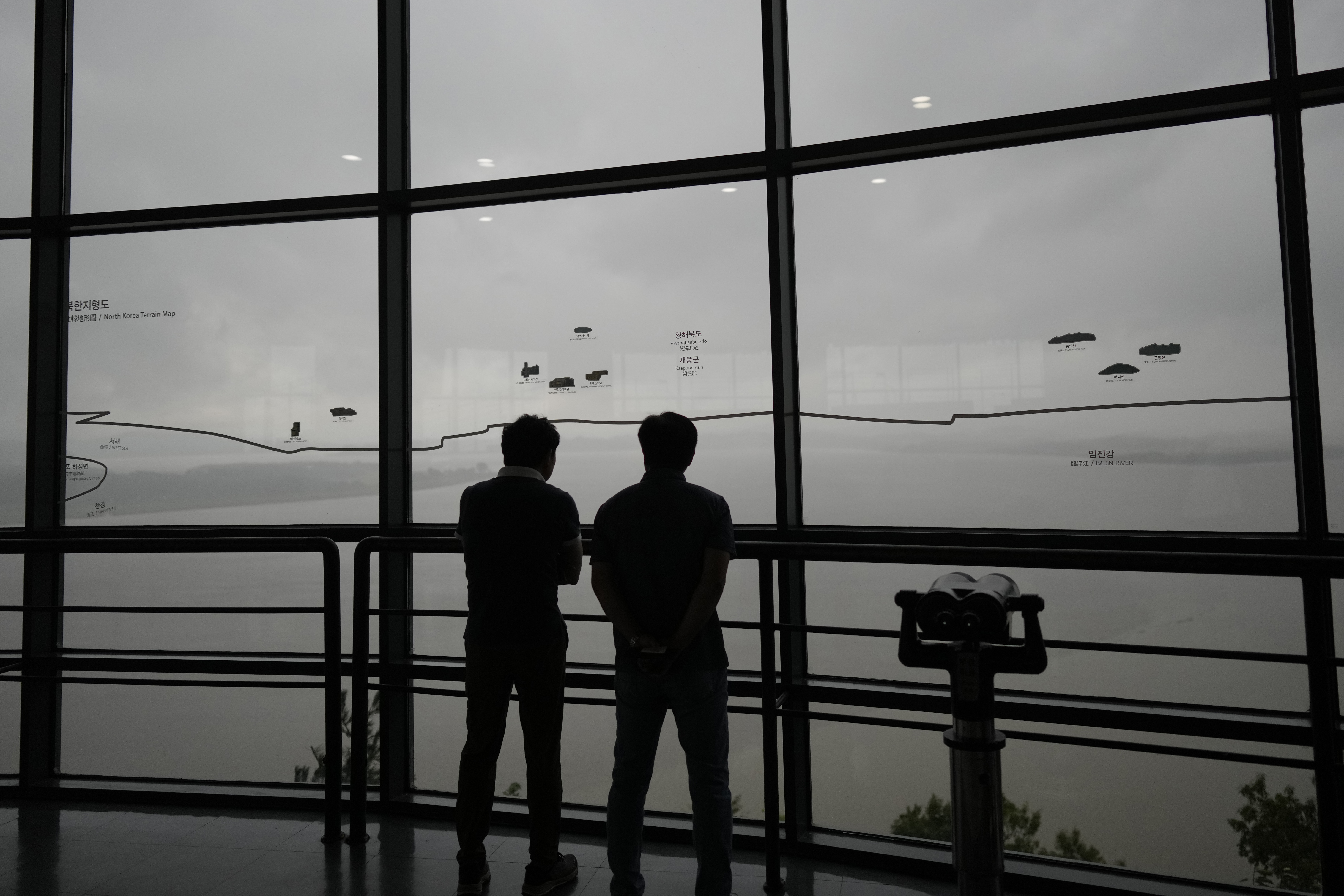 Visitors look at the North Korean side from the unification observatory in Paju, South Korea, Thursday, Sept. 5, 2024. (AP Photo/Lee Jin-man)