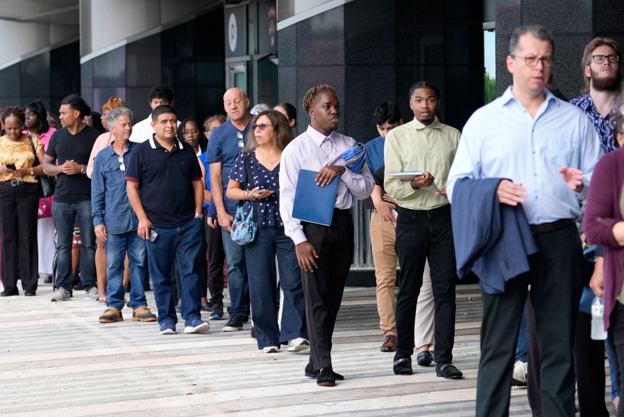 People wait in line to attend a job fair, Thursday, Aug. 29, 2024, in Sunrise, Fla. (AP Photo/Lynne Sladky)