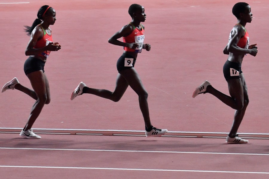 FILE - Hellen Obiri, Rosemary Monica Wanjiru and Agnes Jebet Tirop, from left to right, all of Kenya, compete in the women's 10,000 meter race during the World Athletics Championships in Doha, Qatar, Saturday, Sept. 28, 2019. (AP Photo/Martin Meissner, File)