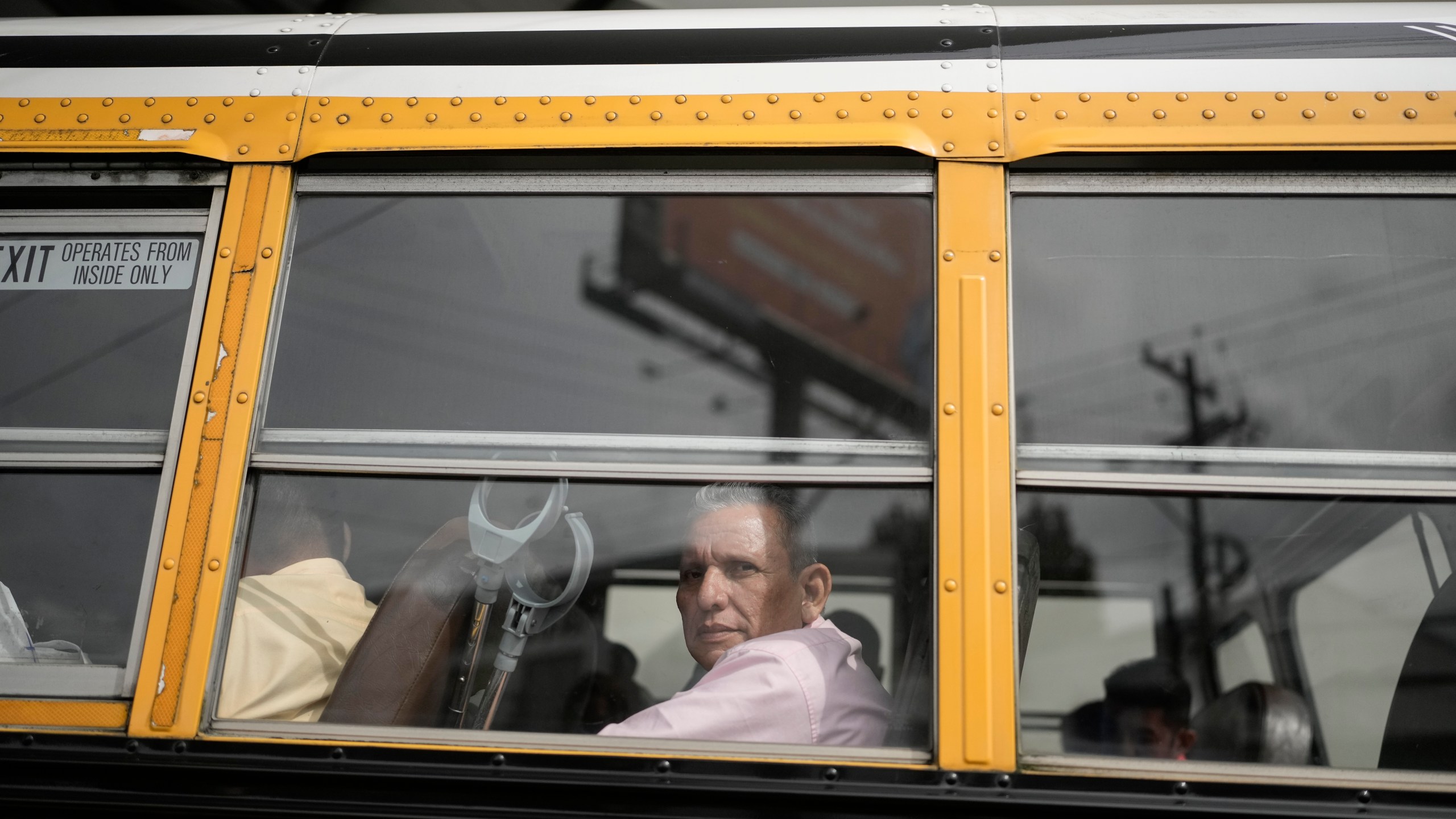 Manuel Rios peers from a bus after being released from a Nicaraguan jail and landing at the airport in Guatemala City, Thursday, Sept. 5, 2024. (AP Photo/Moises Castillo)