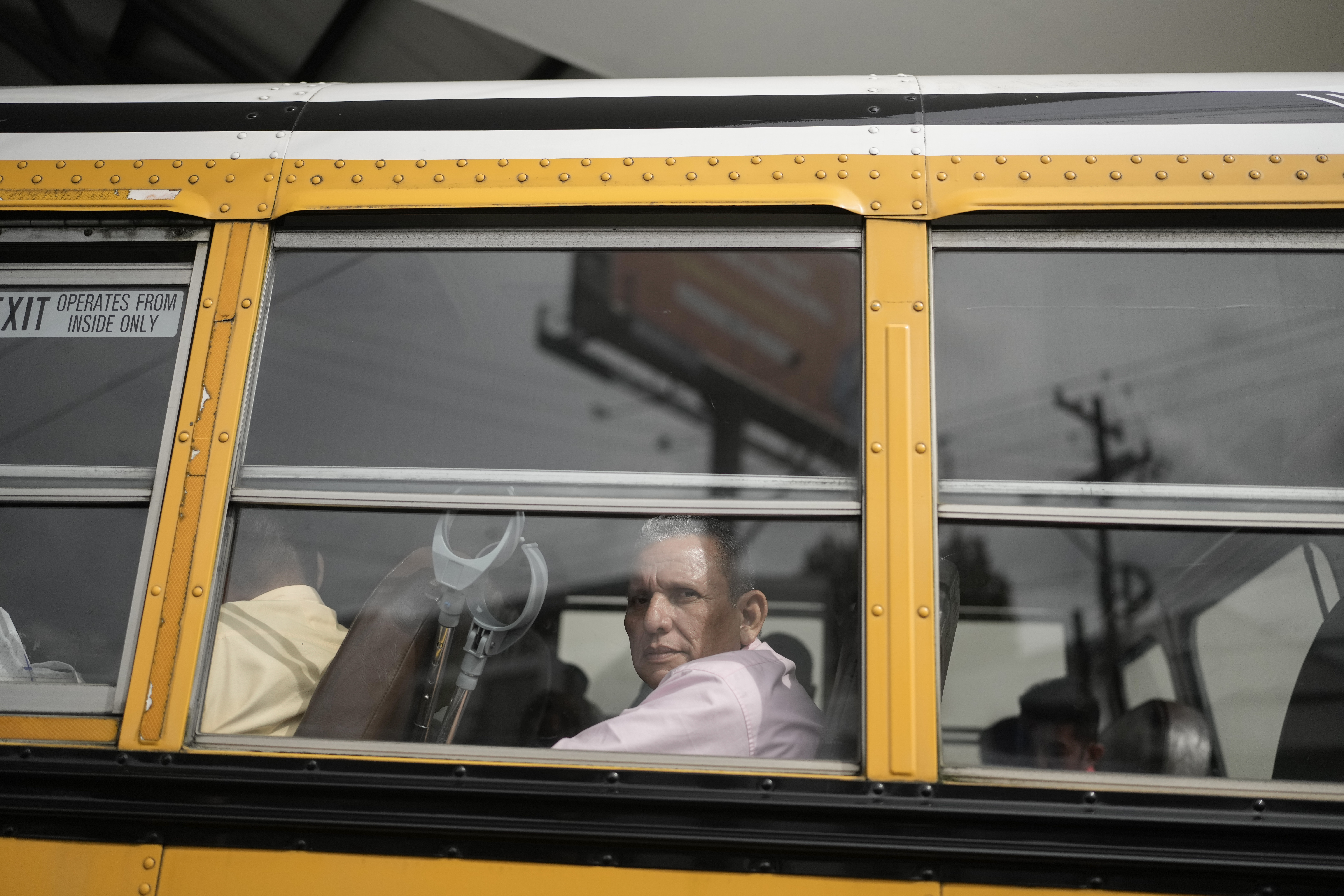 Manuel Rios peers from a bus after being released from a Nicaraguan jail and landing at the airport in Guatemala City, Thursday, Sept. 5, 2024. (AP Photo/Moises Castillo)