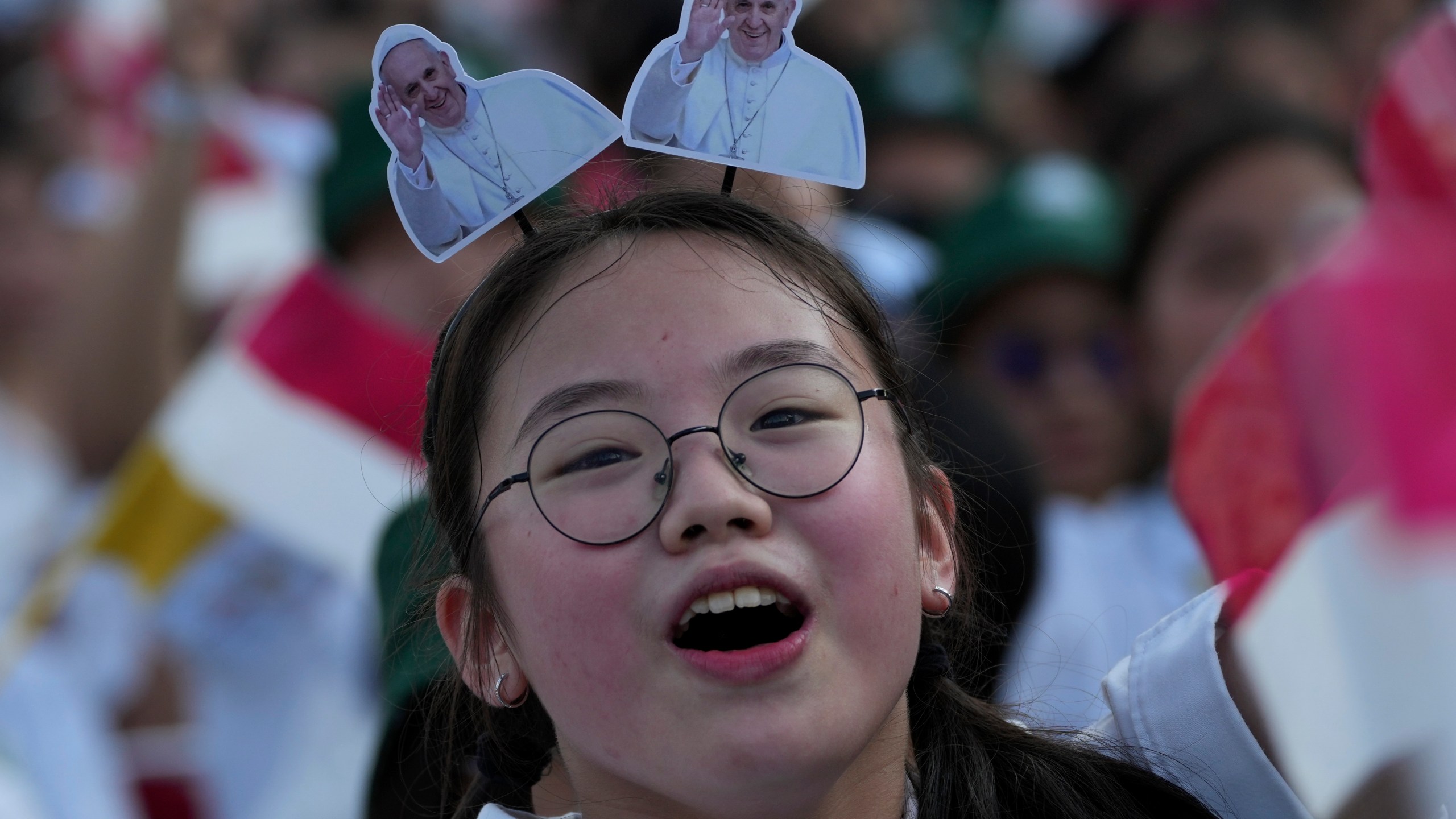 A girl reacts as Pope Francis arrives at Madya Stadium in Jakarta, Indonesia, Thursday, Sept. 5, 2024. (AP Photo/Tatan Syuflana)