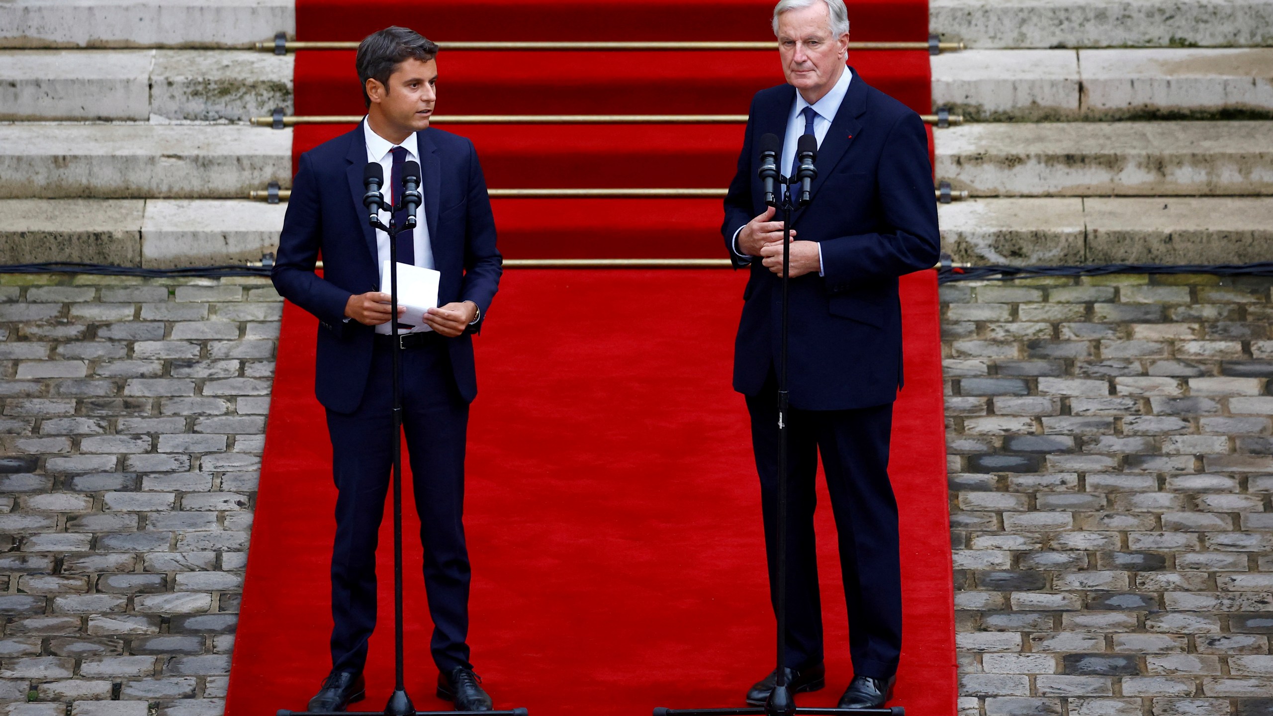 Outgoing French Prime Minister Gabriel Attal, left, and new French prime minister Michel Barnier, right, speak during the handover ceremony, Thursday, Sept. 5, 2024 in Paris. President Emmanuel Macron has named EU's Brexit negotiator Michel Barnier as France's new prime minister after more than 50 days of caretaker government. (Sarah Meyssonnier, Pool Photo via AP)