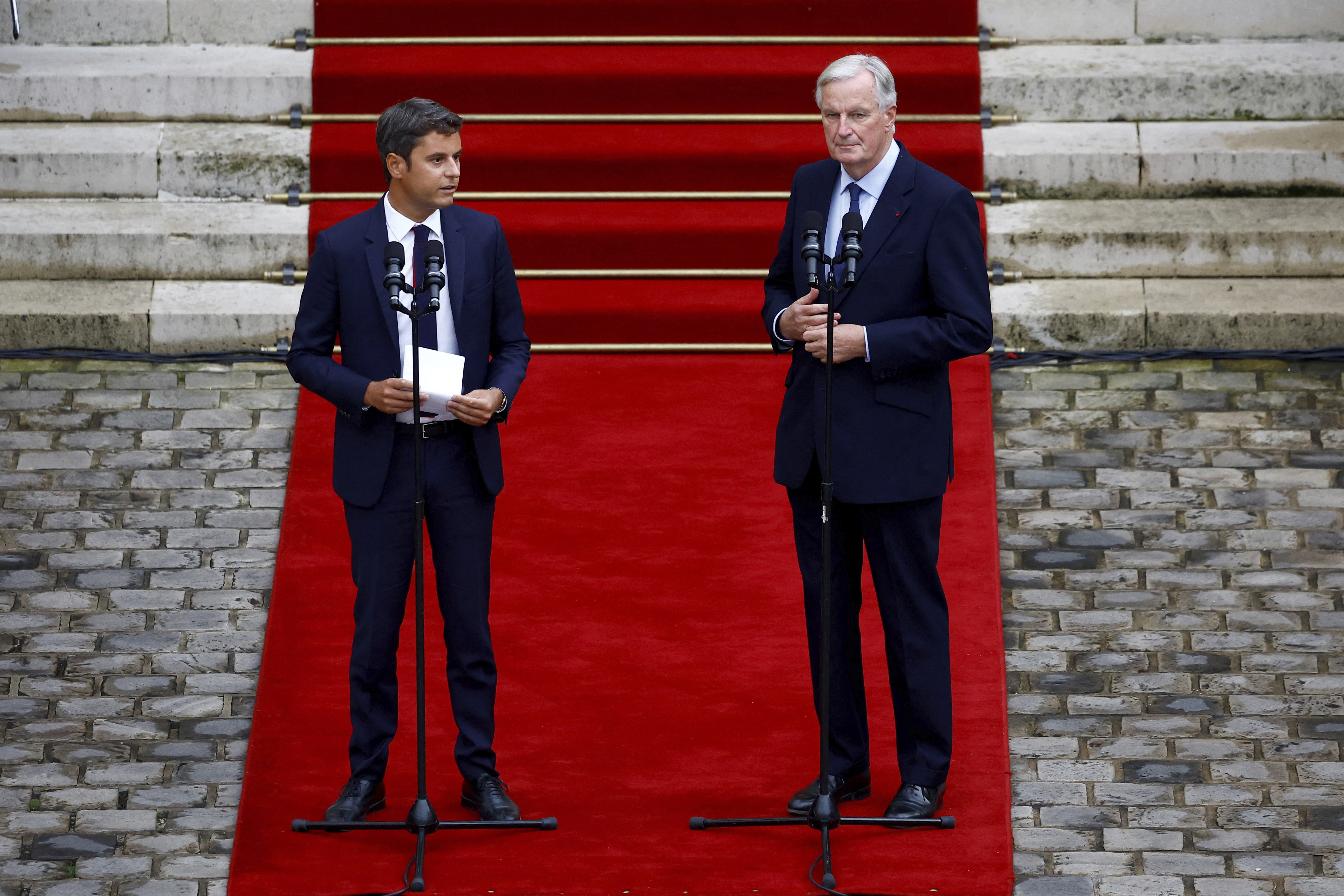 Outgoing French Prime Minister Gabriel Attal, left, and new French prime minister Michel Barnier, right, speak during the handover ceremony, Thursday, Sept. 5, 2024 in Paris. President Emmanuel Macron has named EU's Brexit negotiator Michel Barnier as France's new prime minister after more than 50 days of caretaker government. (Sarah Meyssonnier, Pool Photo via AP)