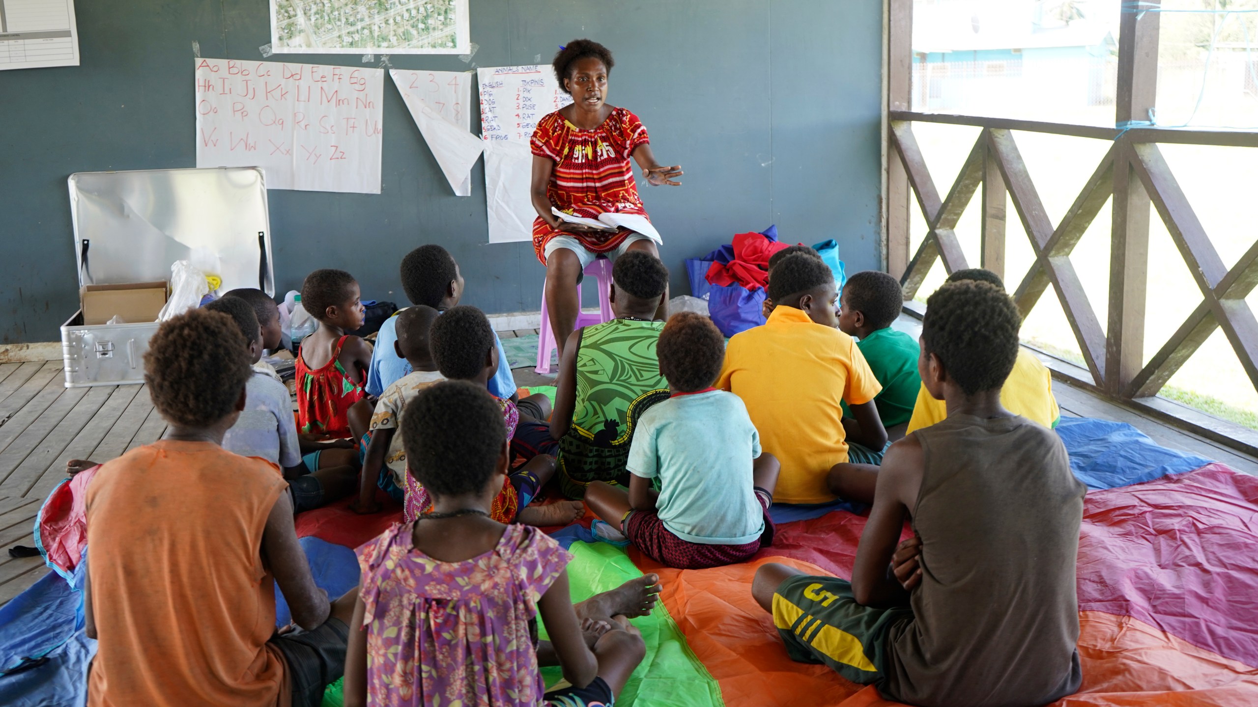 In this undated photo provided by UNICEF PNG, East Sepik massacre survivors participate in a class in a care center in Angoram, Papua New Guinea. (Noreen Chambers/UNICEF PNG via AP)