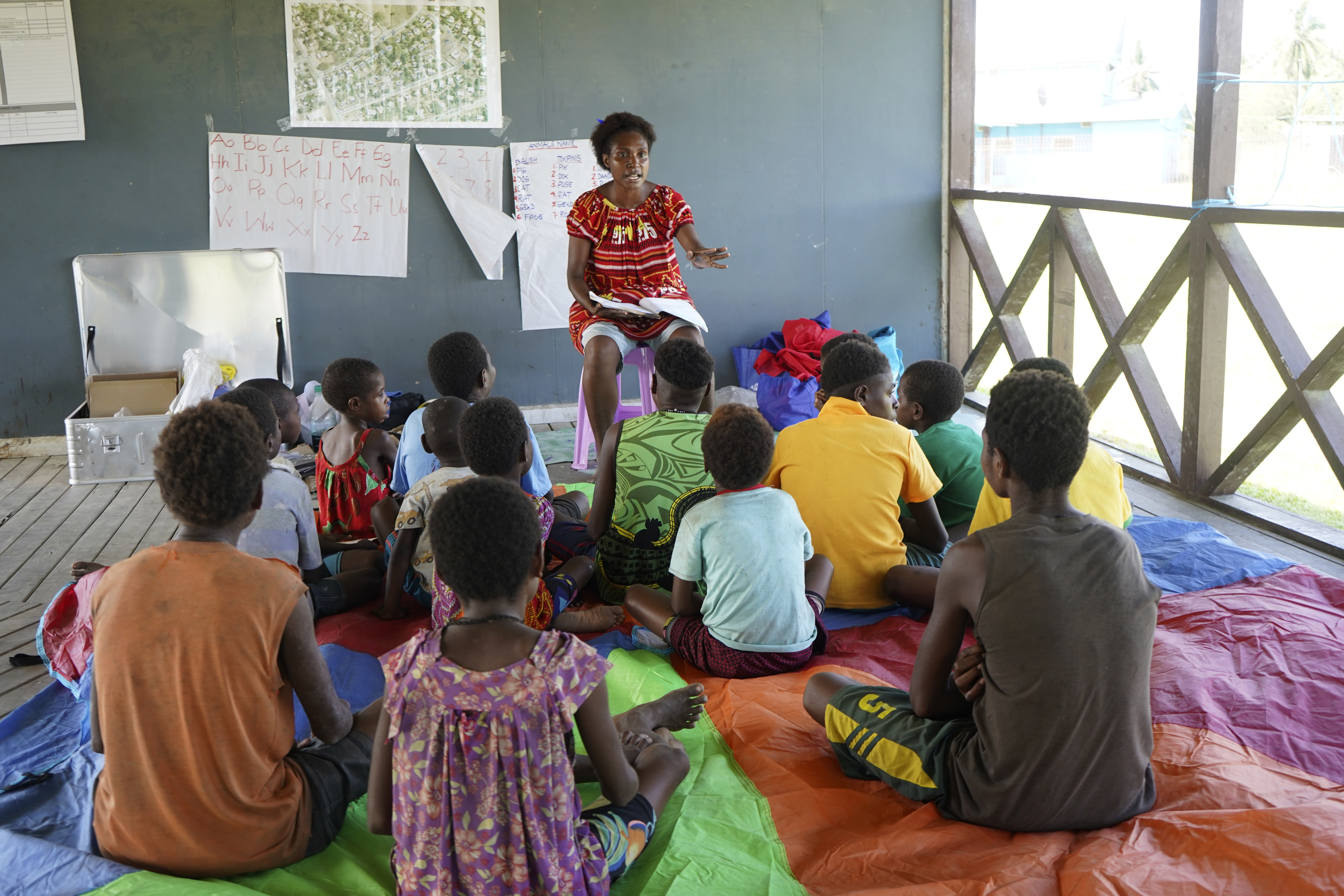 In this undated photo provided by UNICEF PNG, East Sepik massacre survivors participate in a class in a care center in Angoram, Papua New Guinea. (Noreen Chambers/UNICEF PNG via AP)