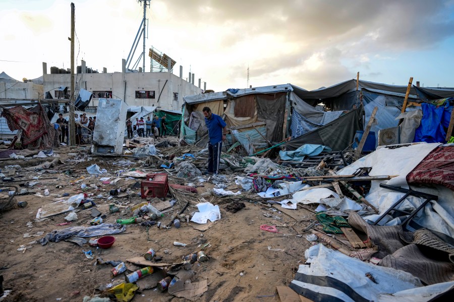 Palestinians inspect the damage at a tent area in the courtyard of Al Aqsa Martyrs hospital, hit by an Israeli bombardment on Deir al-Balah, central Gaza Strip, Thursday, Sept. 5, 2024. (AP Photo/Abdel Kareem Hana)