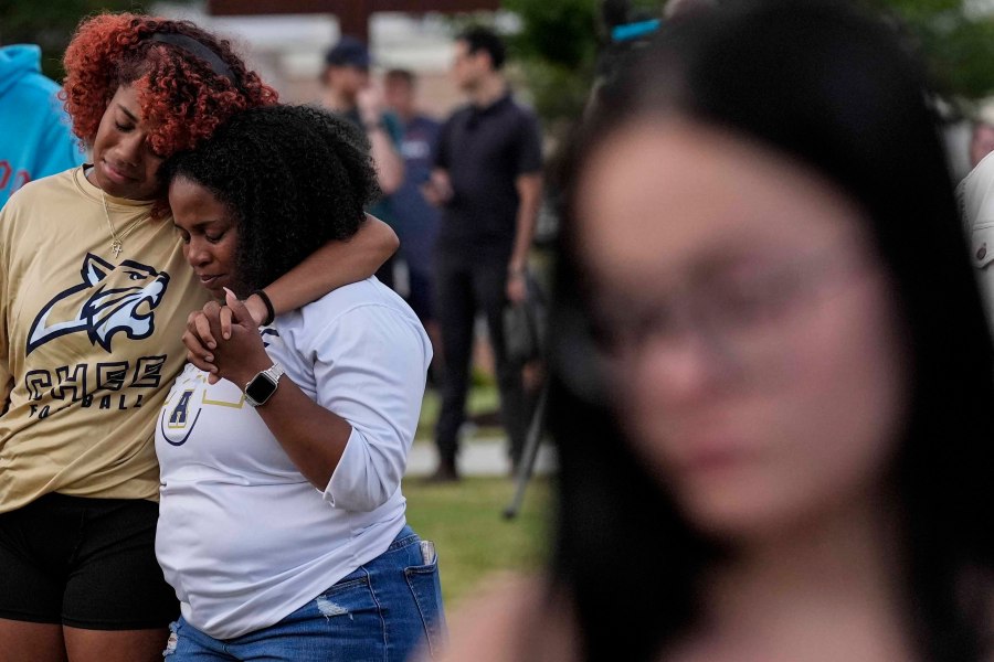 Mourners pray during a candlelight vigil for the slain students and teachers at Apalachee High School, Wednesday, Sept. 4, 2024, in Winder, Ga. (AP Photo/Mike Stewart)