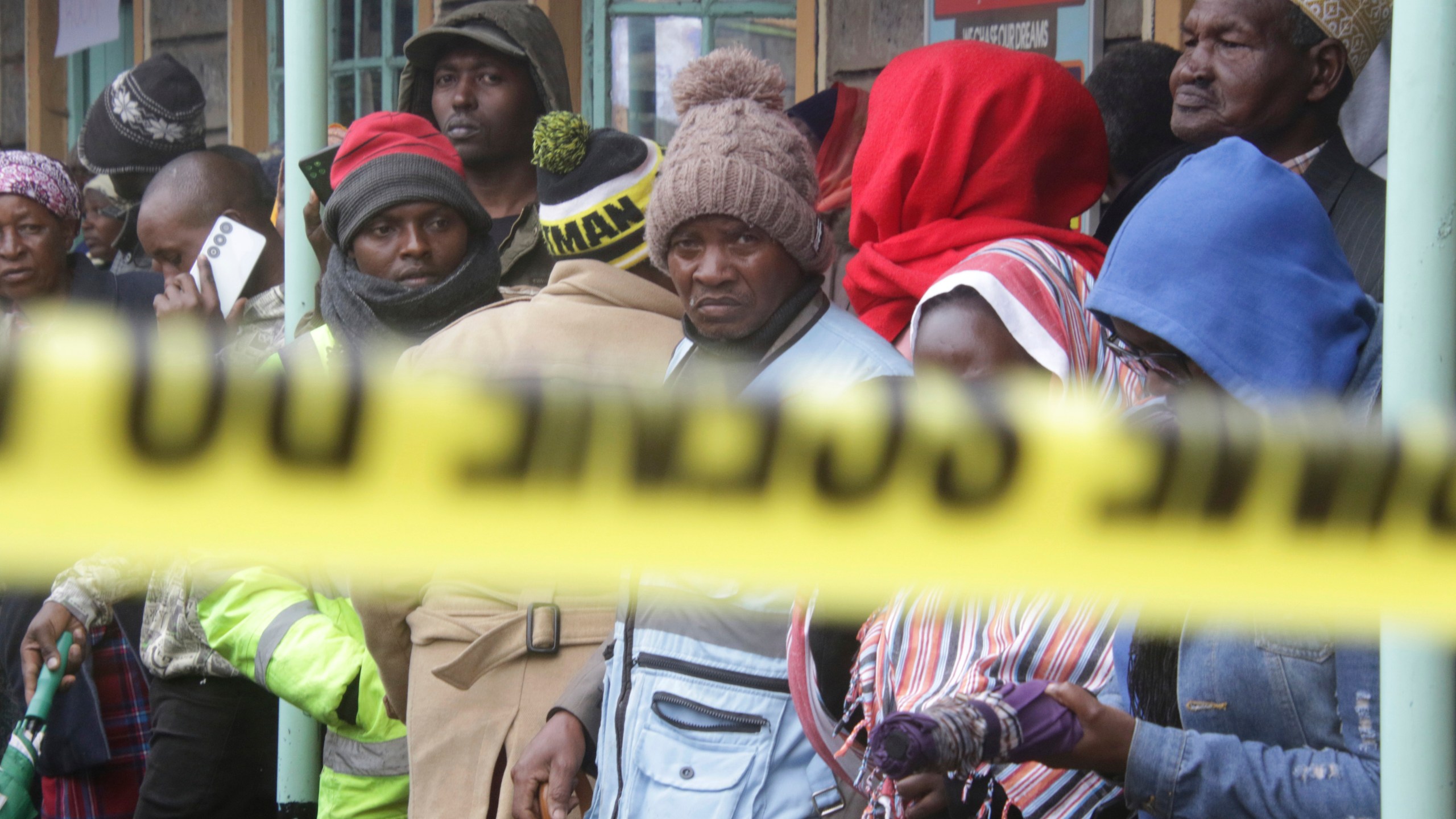 Distressed parents stand near a burnt-out dormitory, following a fire at the Hillside Endarasha Primary in Nyeri, Kenya Friday, Sep. 6, 2024. (AP Photo)