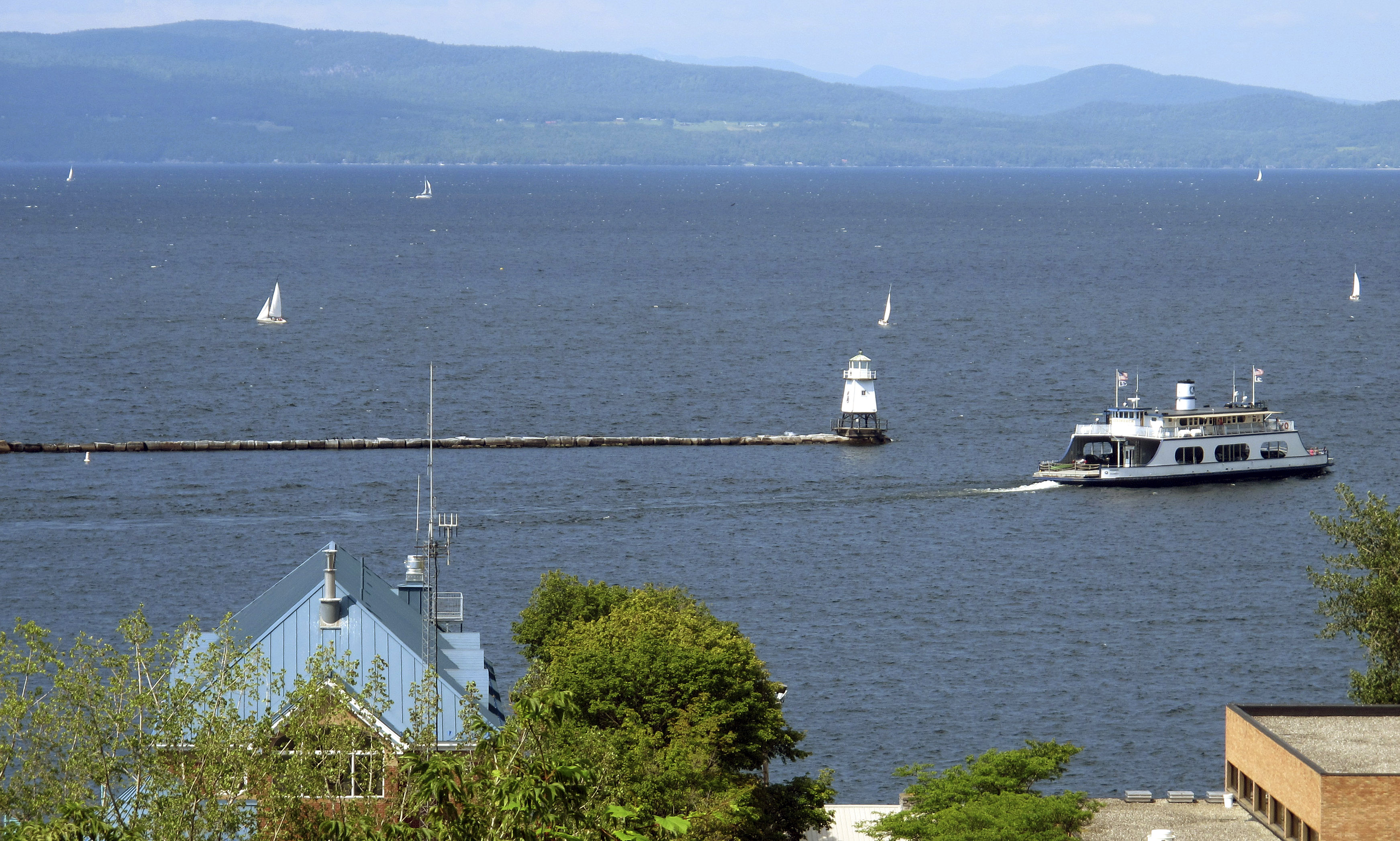 FILE - Sailboats and a passenger ferry dot Lake Champlain as seen from Battery Park, Aug. 14, 2015 in Burlington, Vt. (AP Photo/Wilson Ring, File)