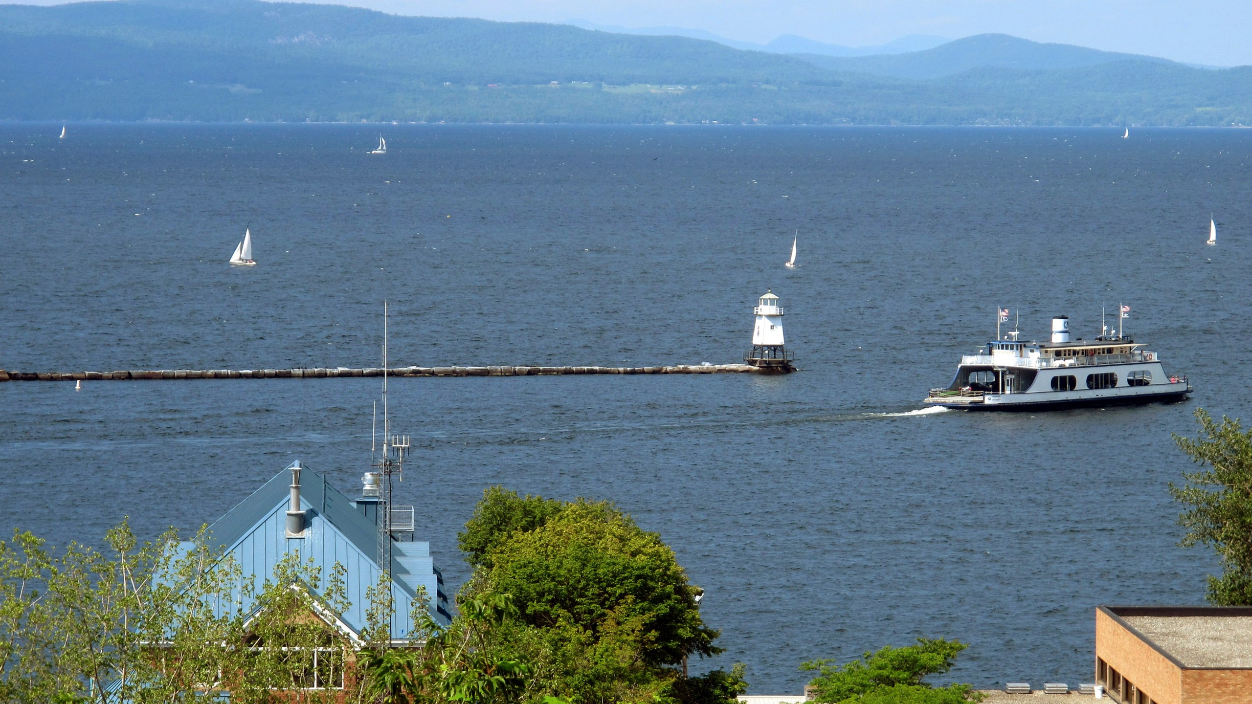 FILE - Sailboats and a passenger ferry dot Lake Champlain as seen from Battery Park, Aug. 14, 2015 in Burlington, Vt. (AP Photo/Wilson Ring, File)