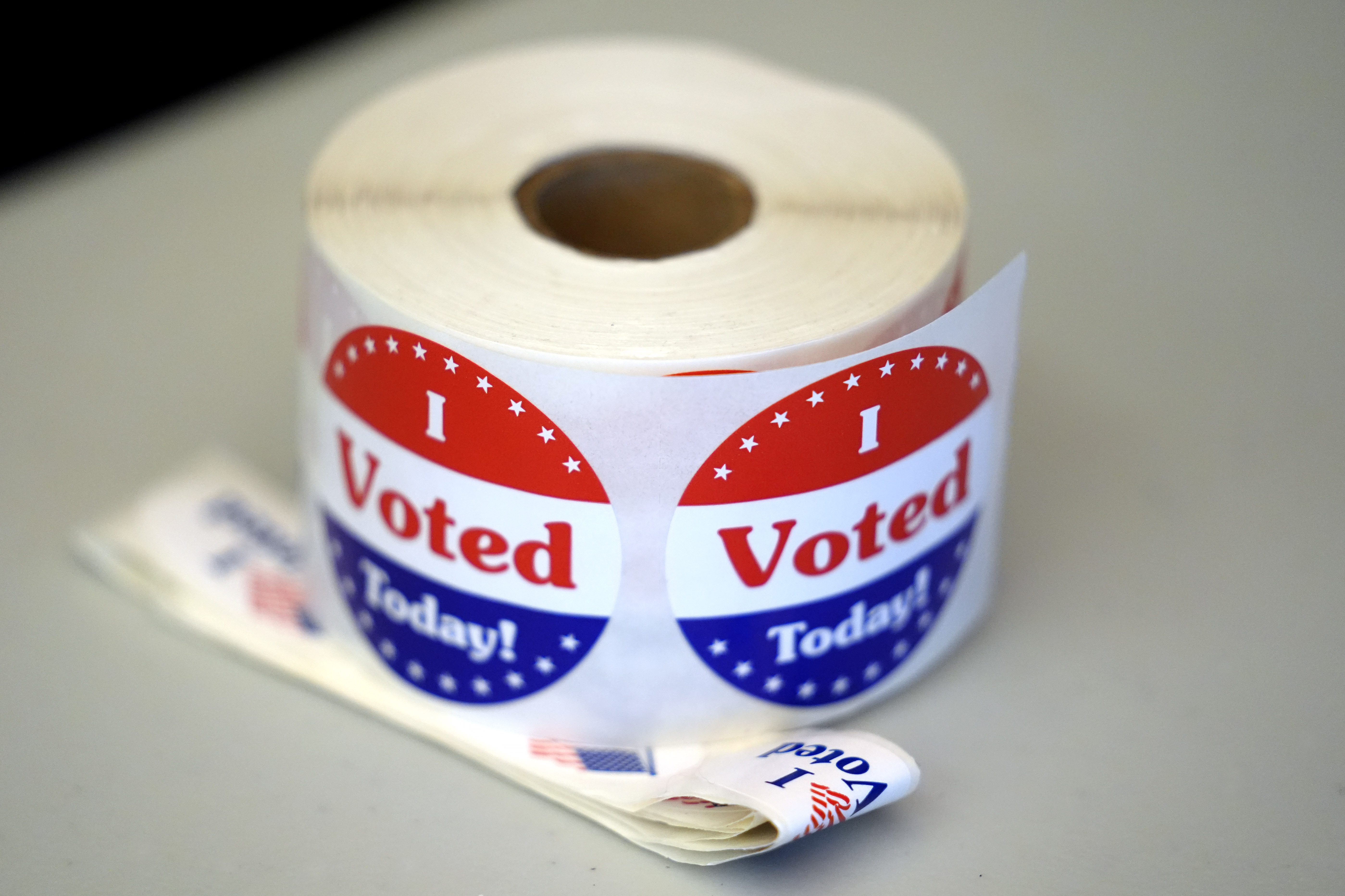 FILE - A spool of stickers rests on a table at a polling station during Massachusetts state primary voting, Sept. 3, 2024, in Newton, Mass. (AP Photo/Steven Senne, File)