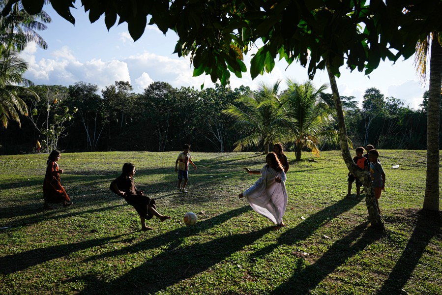 Ashaninka Indigenous children play with a ball in the Apiwtxa village, near Marechal Thaumaturgo city, Acre state, Brazil, Saturday, June 22, 2024. (AP Photo/Jorge Saenz)