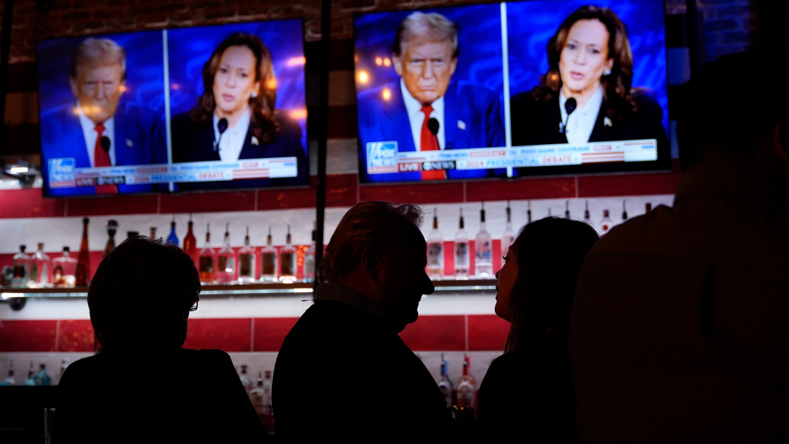 Viewers gather to watch a debate between Democratic presidential nominee Vice President Kamala Harris and Republican presidential nominee former President Donald Trump at the Angry Elephant Bar and Grill, Tuesday, Sept. 10, 2024, in San Antonio. (AP Photo/Eric Gay)