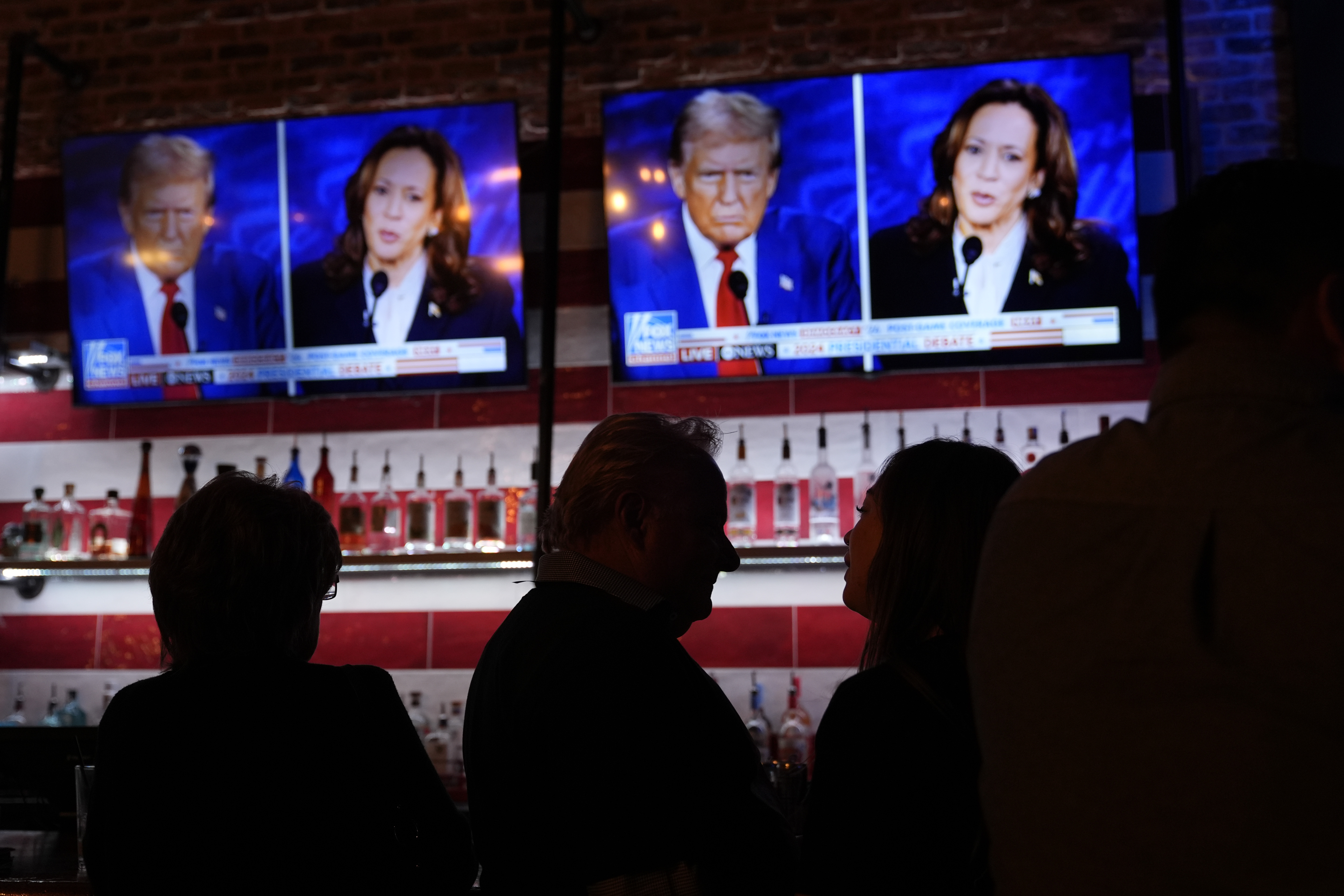 Viewers gather to watch a debate between Democratic presidential nominee Vice President Kamala Harris and Republican presidential nominee former President Donald Trump at the Angry Elephant Bar and Grill, Tuesday, Sept. 10, 2024, in San Antonio. (AP Photo/Eric Gay)