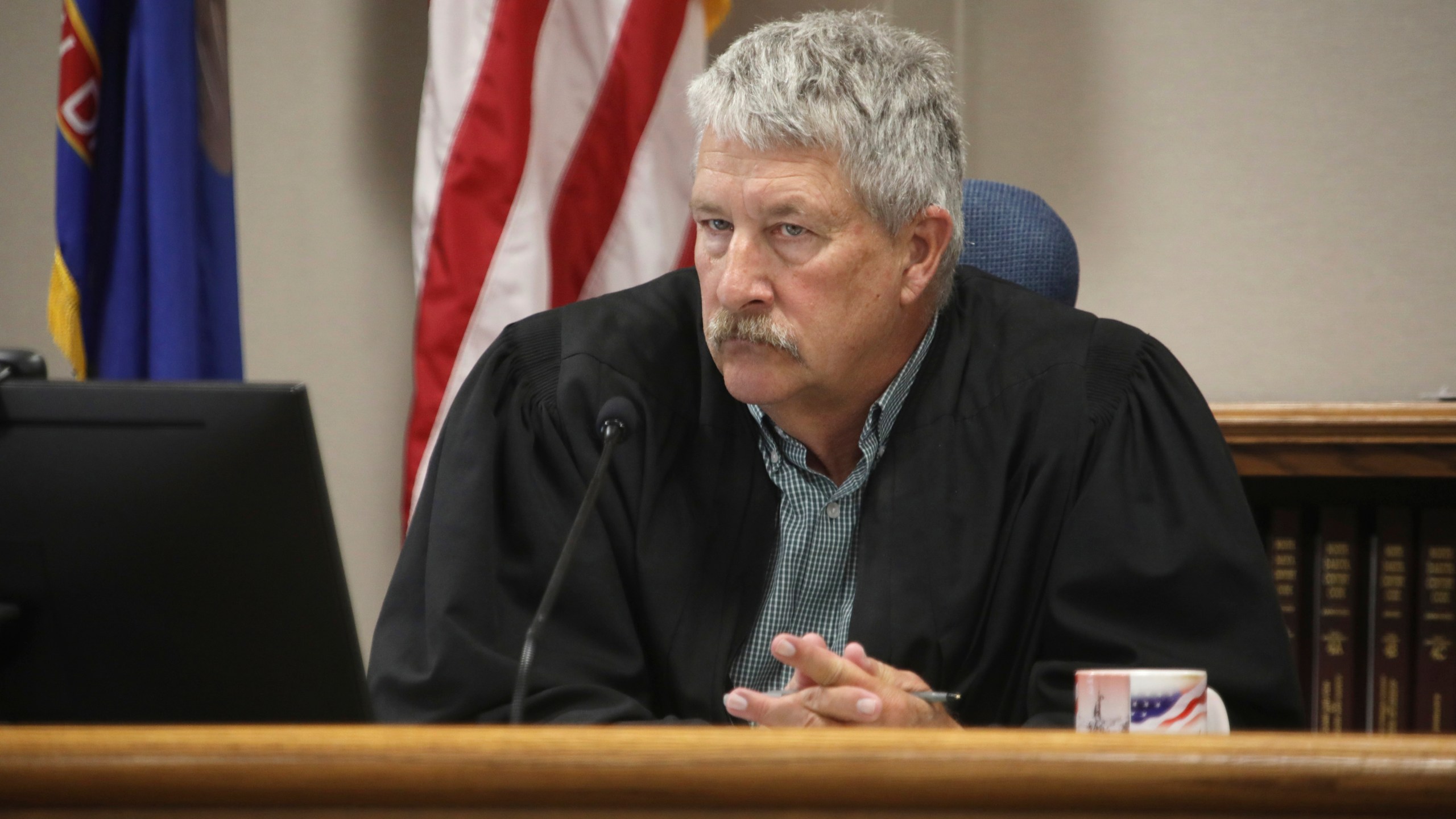 FILE - South Central District Judge Bruce Romanick listens to arguments by attorneys during a hearing challenging North Dakota's abortion laws, July 23, 2024, in Bismarck, N.D. (Brad Nygaard/The Bismarck Tribune via AP, File)