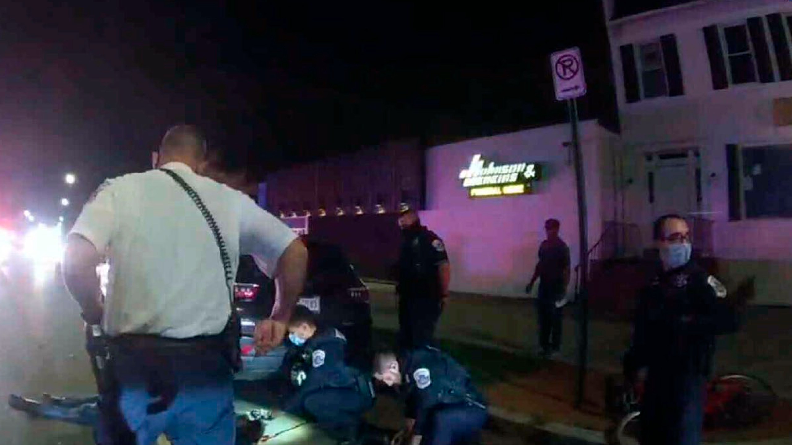 This Metropolitan Police Department police-worn body cam image from video, contained in the Justice Department's sentencing memorandum, shows Karon Hylton-Brown, 20, on the ground, after a moped chase on Oct. 23, 2020, in Washington. (Department of Justice via AP)