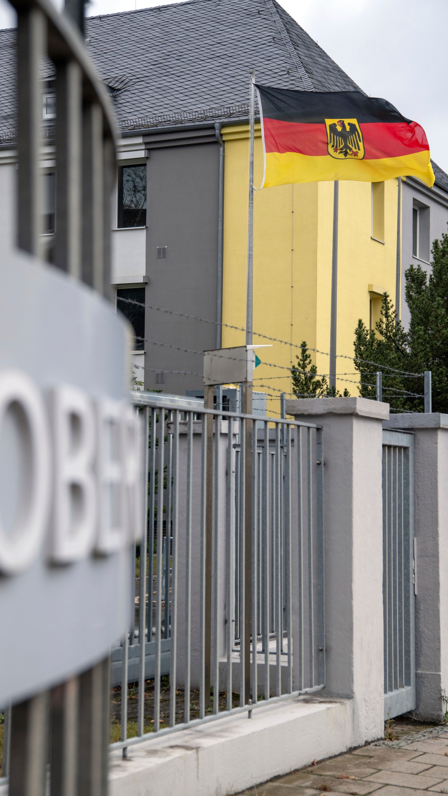 A German flag flies at the entrance to the Upper Franconia barracks, in Hof, Germany. Investigators in Bavaria have arrested a 27-year-old Syrian man for planning to attack Bundeswehr soldiers in Upper Franconia. (Pia Bayer/dpa via AP)