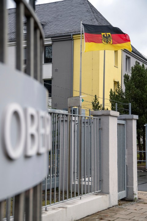 A German flag flies at the entrance to the Upper Franconia barracks, in Hof, Germany. Investigators in Bavaria have arrested a 27-year-old Syrian man for planning to attack Bundeswehr soldiers in Upper Franconia. (Pia Bayer/dpa via AP)