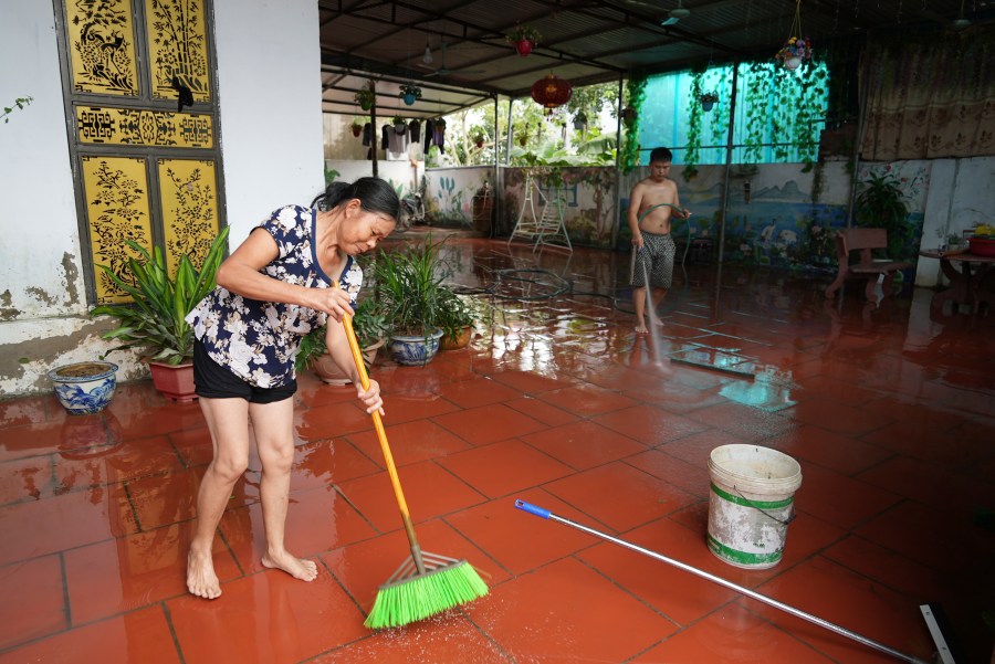 People clean their house after flood recedes in the aftermath of Typhoon Yagi in An Lac village, Hanoi, Vietnam Friday, Sept. 13, 2024. (AP Photo/Hau Dinh)