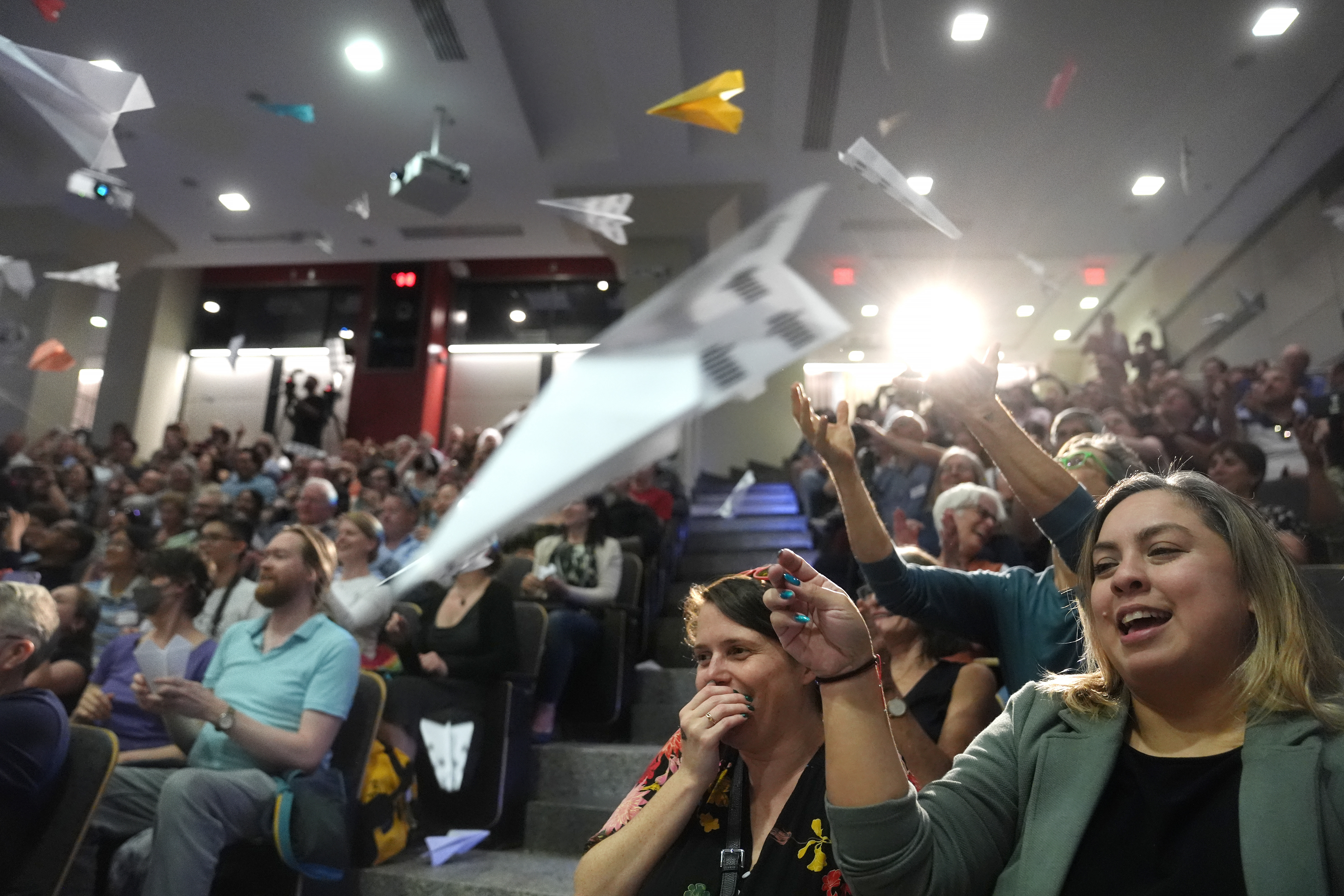 People in the audience throw paper airplanes toward the stage during a performance at the Ig Nobel Prize ceremony at Massachusetts Institute of Technology in Cambridge, Mass., Thursday, Sept. 12, 2024. (AP Photo/Steven Senne)