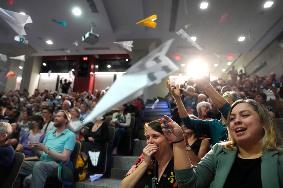 People in the audience throw paper airplanes toward the stage during a performance at the Ig Nobel Prize ceremony at Massachusetts Institute of Technology in Cambridge, Mass., Thursday, Sept. 12, 2024. (AP Photo/Steven Senne)