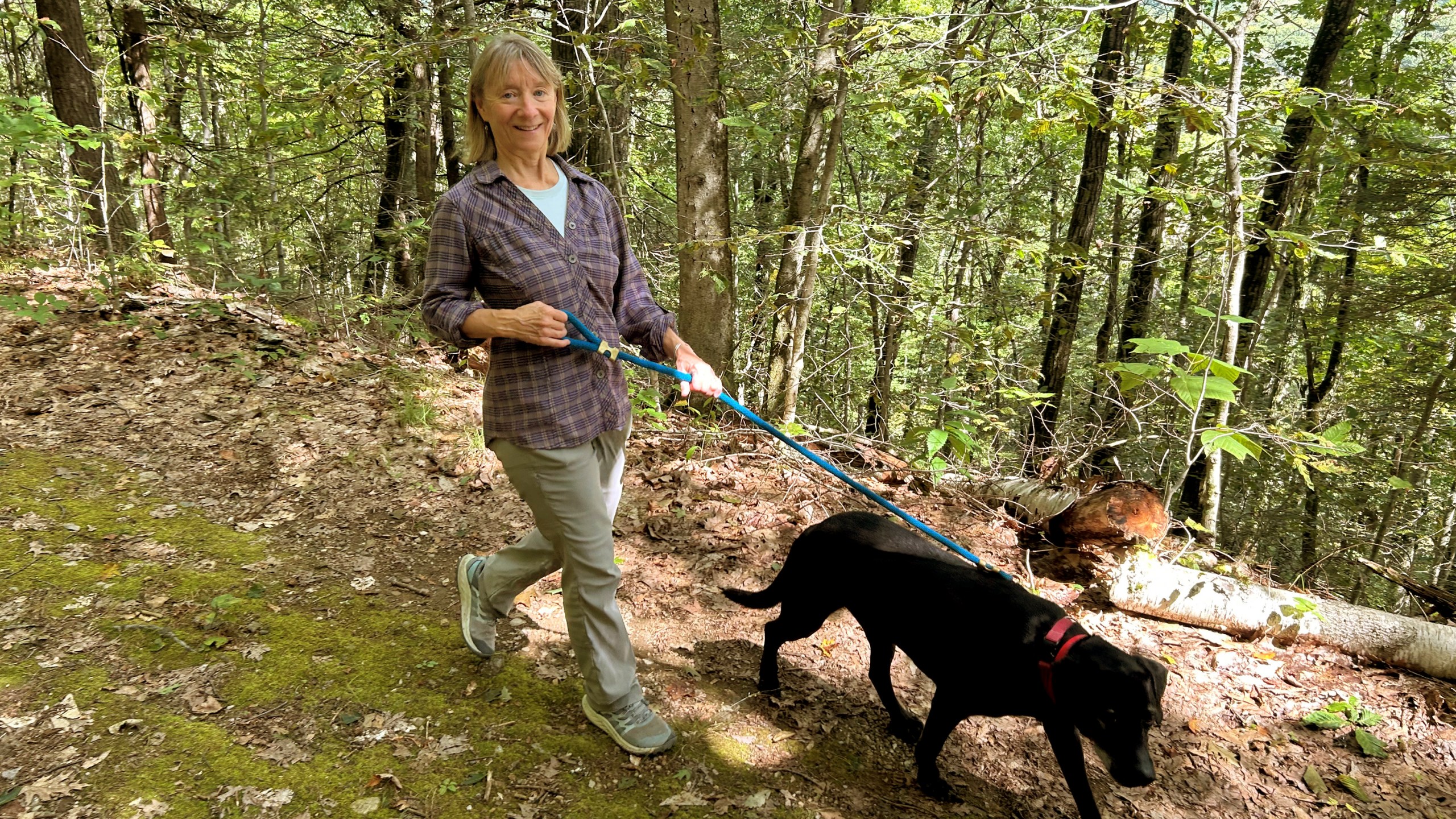 Susannah Johnston, of Croton-on-Hudson, N.Y., walks her dog Ellie on Sept. 8, 2024 in Norfolk, Conn. Johnston, a fit yoga instructor and strength trainer, has been injured three times in incidents involving walking her dog. (Vincent Cohan via AP)