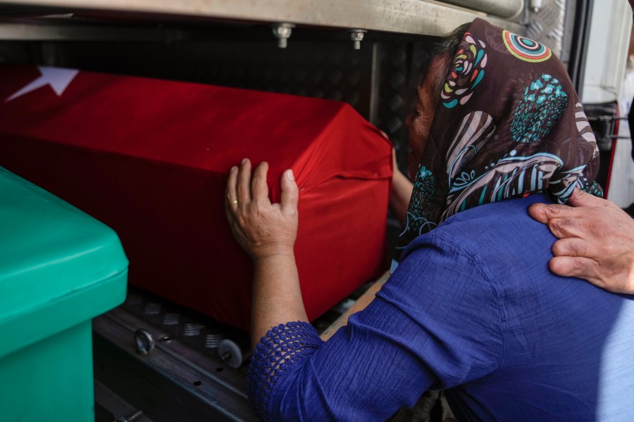 A relative of Aysenur Ezgi Eygi, a 26 year-old Turkish-American activist killed by the Israeli military, mourns over her coffin during her funeral in Didim, Turkey, Saturday, Sept. 14, 2024,(AP Photo/Khalil Hamra)