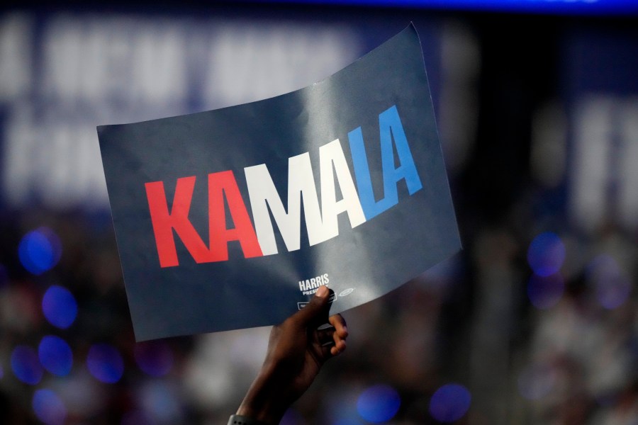 A supporter holds up a sign as Democratic presidential nominee Vice President Kamala Harris speaks during a campaign event, Thursday, Sept. 12, 2024, in Greensboro, N.C. (AP Photo/Chris Carlson)