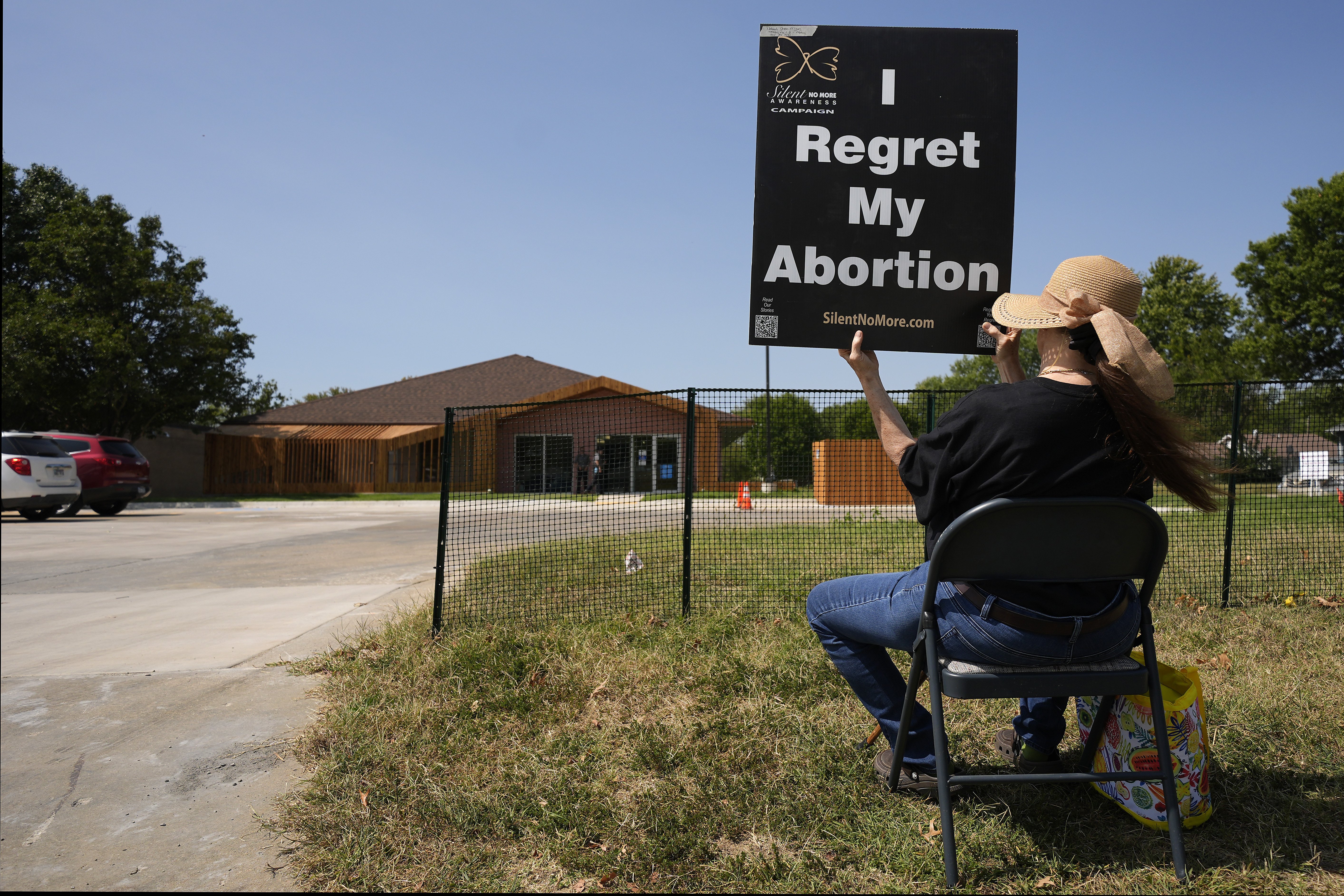 Anti-abortion protester Deborah Green-Myers, from Pittsburg, Kan., demonstrates outside a recently opened Planned Parenthood clinic, Tuesday, Sept. 10, 2024, in Pittsburg, Kan. (AP Photo/Charlie Riedel)