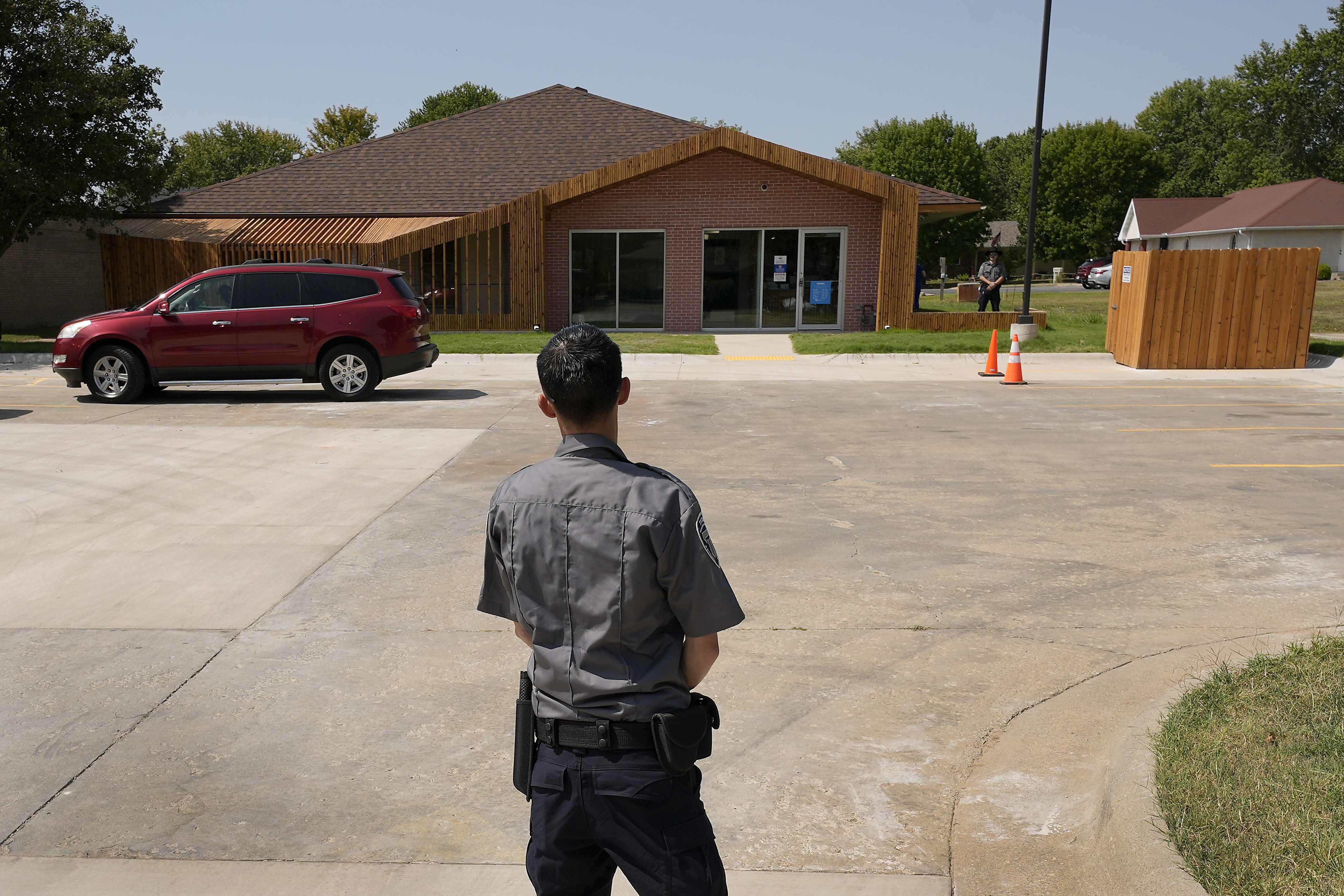 Security personnel stand outside a recently opened Planned Parenthood clinic, Tuesday, Sept. 10, 2024, in Pittsburg, Kan., that is serving patients from Kansas as well as nearby Missouri, Oklahoma, Arkansas, Texas, and other states. (AP Photo/Charlie Riedel)