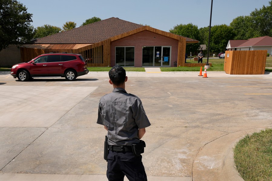 Security personnel stand outside a recently opened Planned Parenthood clinic, Tuesday, Sept. 10, 2024, in Pittsburg, Kan., that is serving patients from Kansas as well as nearby Missouri, Oklahoma, Arkansas, Texas, and other states. (AP Photo/Charlie Riedel)