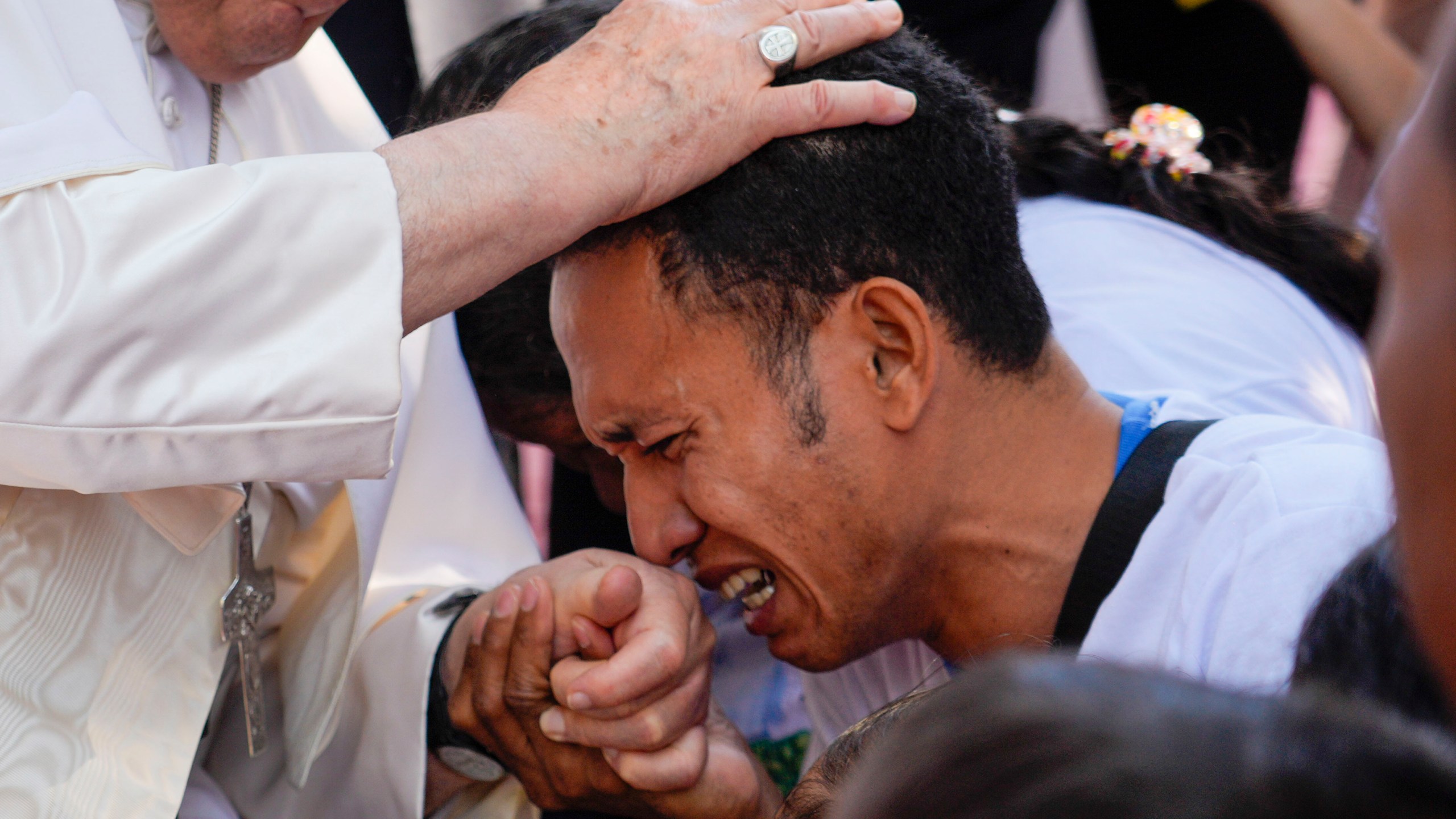 Pope Francis consoles a person during a visit at the 'Irmas ALMA' (Sisters of the Association of Lay Missionaries) School for Children with Disabilities in Dili, East Timor, Tuesday, Sept. 10, 2024. (AP Photo/Gregorio Borgia)