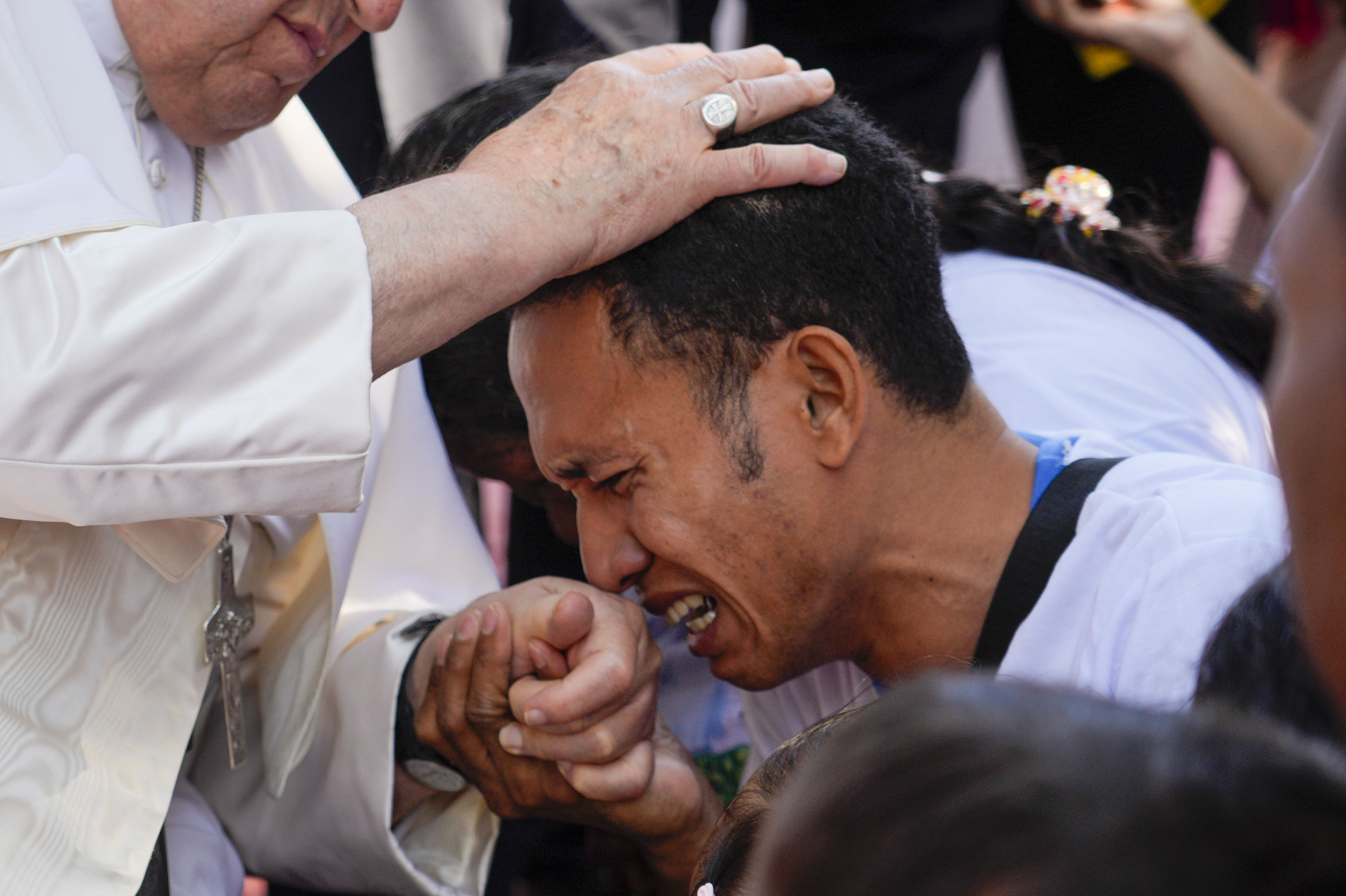 Pope Francis consoles a person during a visit at the 'Irmas ALMA' (Sisters of the Association of Lay Missionaries) School for Children with Disabilities in Dili, East Timor, Tuesday, Sept. 10, 2024. (AP Photo/Gregorio Borgia)