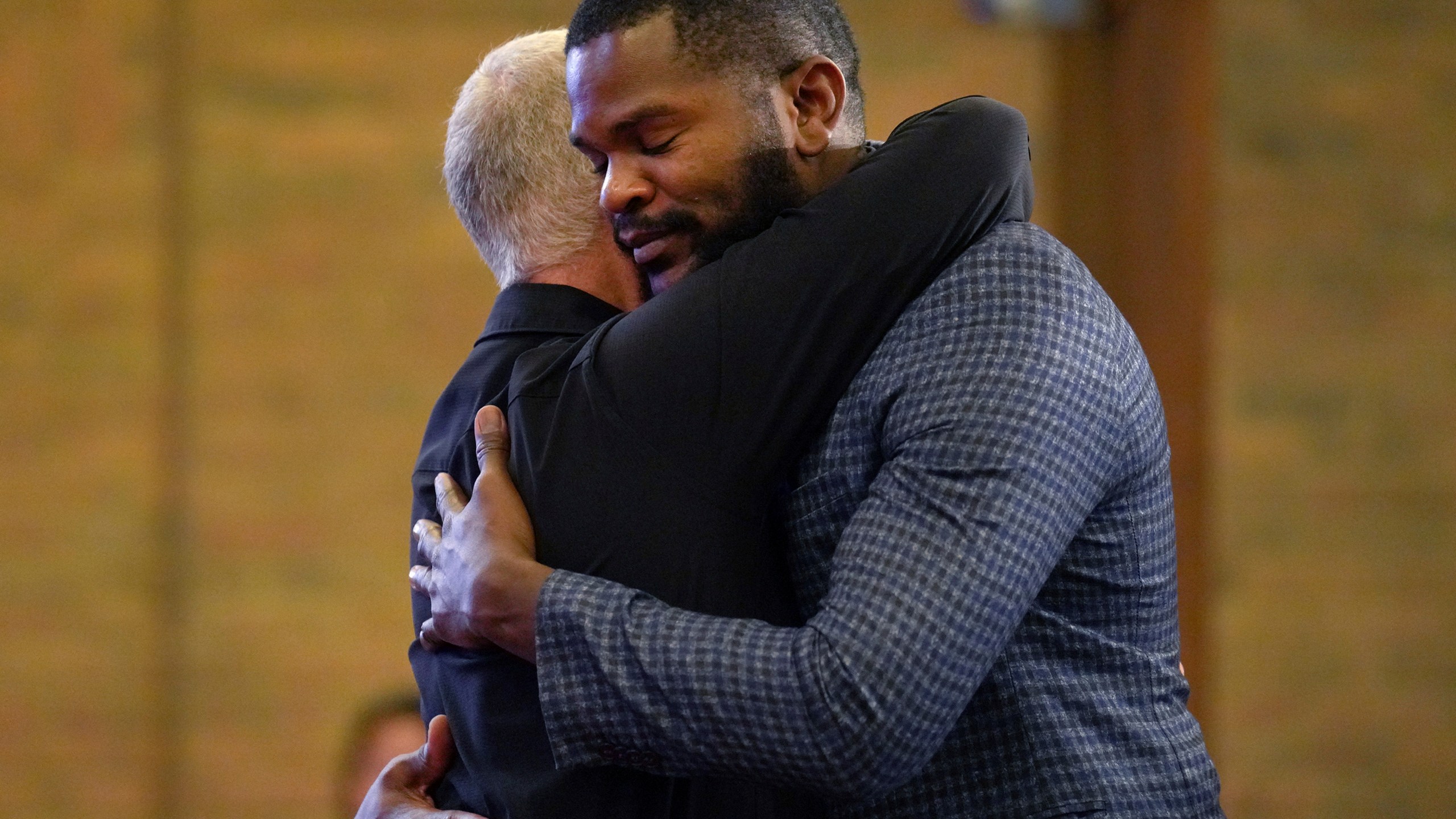 Carl Ruby, pastor at Central Christian Church, hugs Lindsay Aime during service, on Sunday, Sept. 15, 2024, in Springfield, Ohio. (AP Photo/Jessie Wardarski)