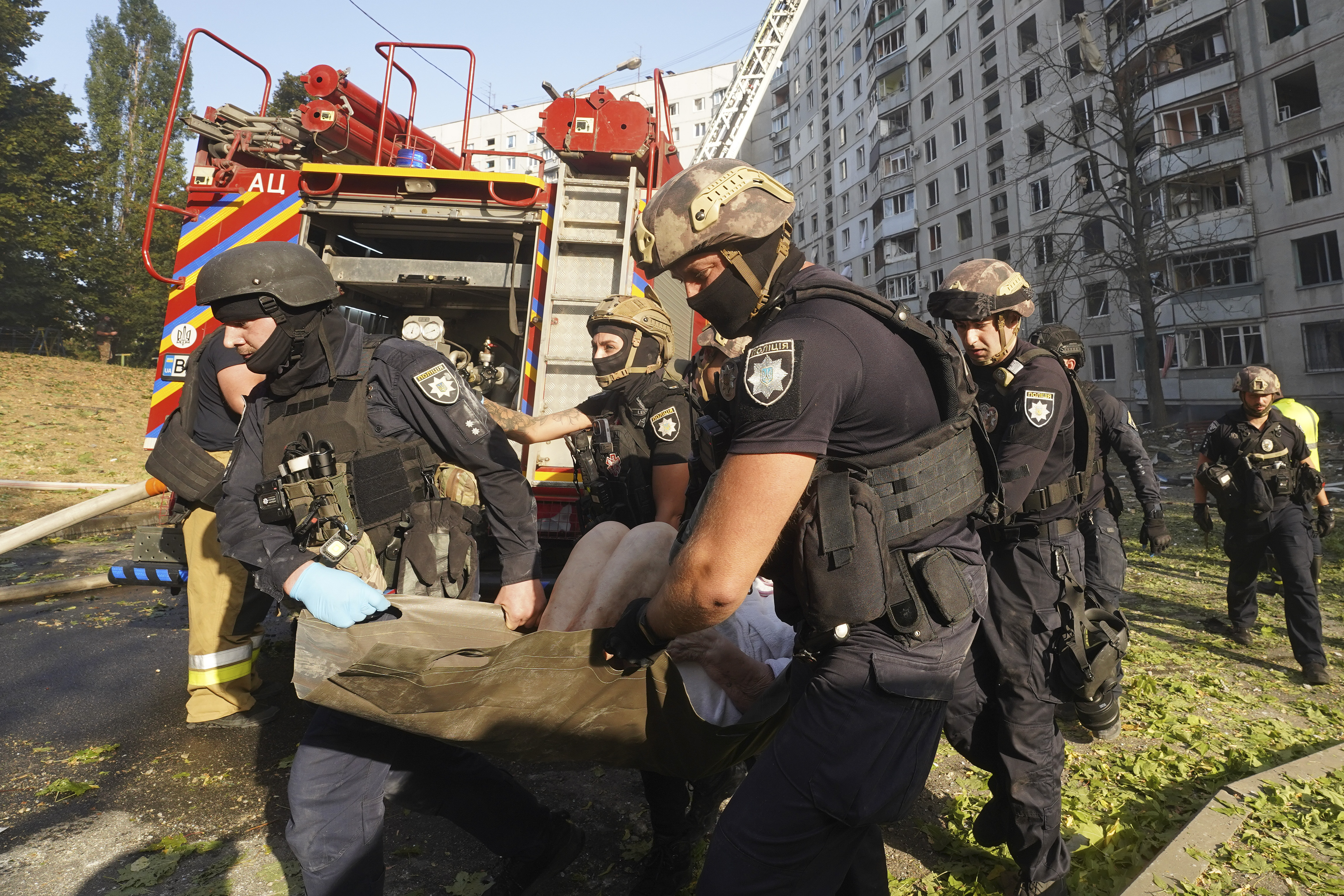 A wounded person is carried away after a Russian aerial bomb struck a multi-story residential building in Kharkiv, Ukraine, Sunday Sept. 15, 2024. (AP Photo/Andrii Marienko)