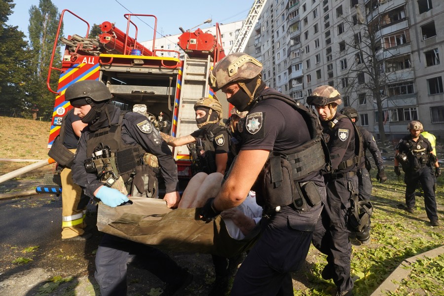 A wounded person is carried away after a Russian aerial bomb struck a multi-story residential building in Kharkiv, Ukraine, Sunday Sept. 15, 2024. (AP Photo/Andrii Marienko)