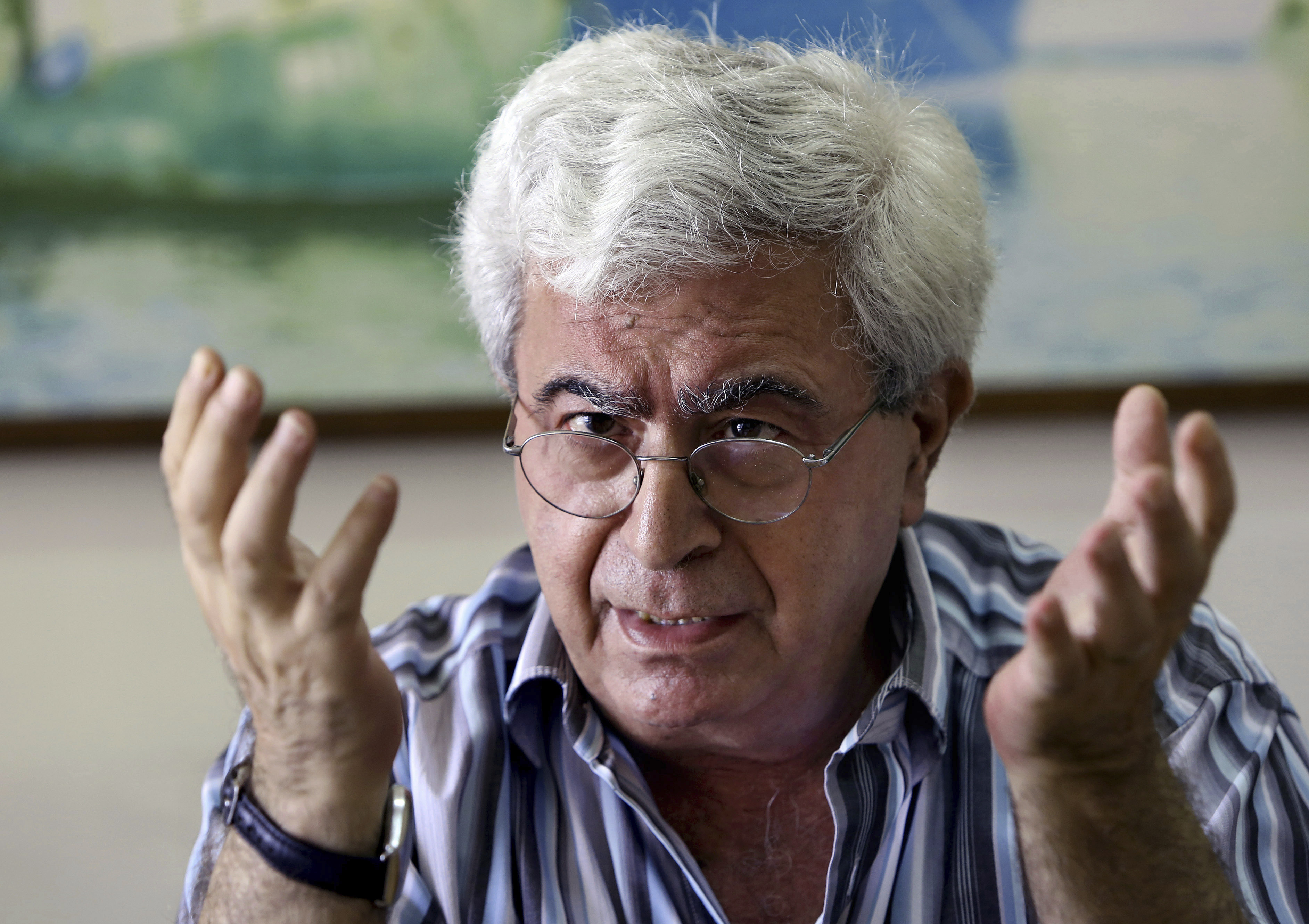 FILE - Lebanese prominent writer and intellectual Elias Khoury speaks during an interview with The Associated Press at his office in the Institute for Palestine Studies in Beirut, Lebanon, Friday, Aug. 8, 2014. (AP Photo/Bilal Hussein, File)