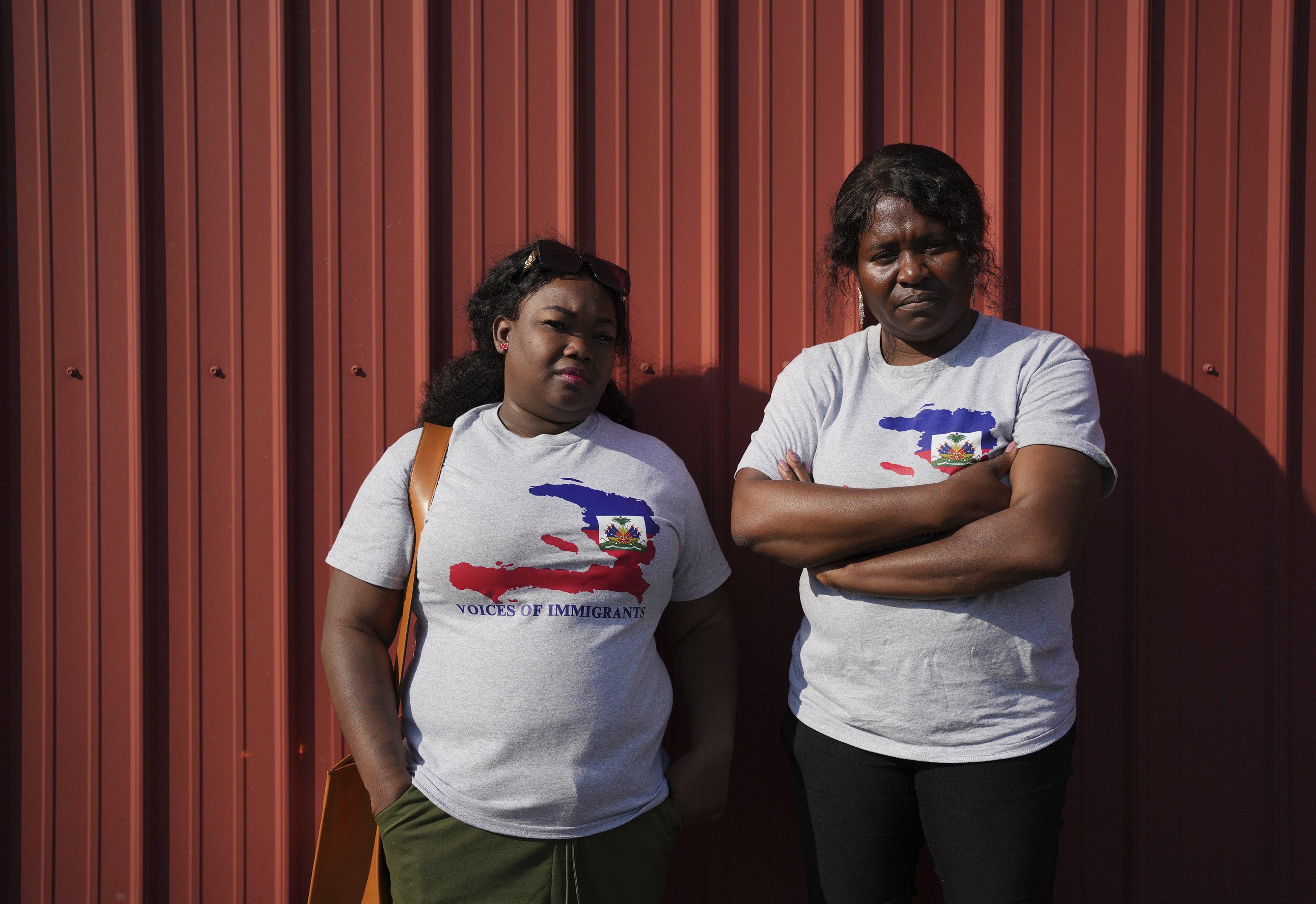 Mia Perez, left, an immigration lawyer, and Bernardette Dor, a pastor at the First Haitian Church, pose for a photo together after joining a prayer walk in support of their Haitian immigrant community in Springfield, Ohio, Saturday, Sept. 14, 2024. (AP Photo/Luis Andres Henao)