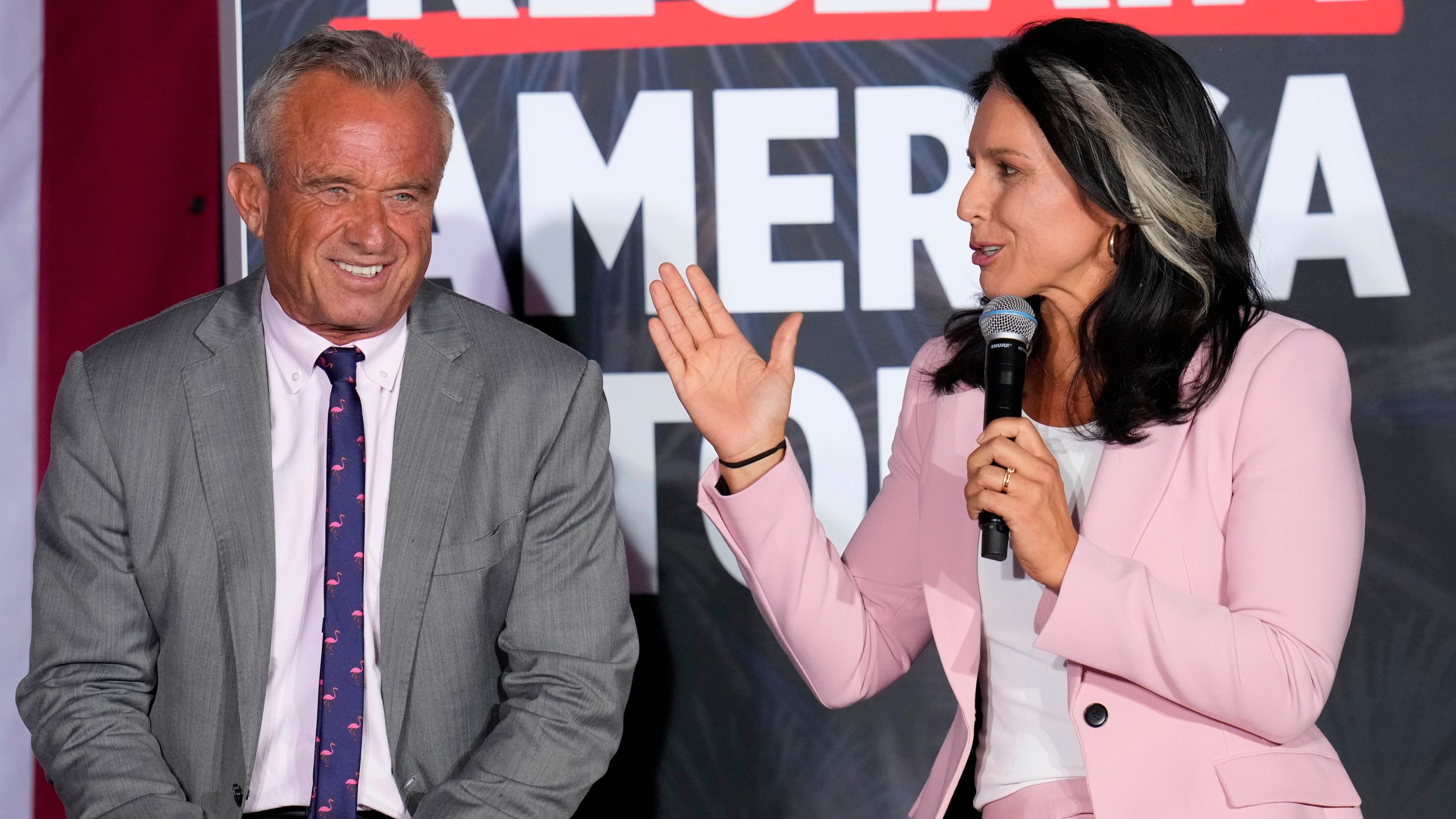 Former Independent candidate for president Robert F. Kennedy, Jr., left, and former Democratic Rep. Tulsi Gabbard speak at a campaign event for Republican presidential nominee former President Donald Trump, Saturday, Sept. 14, 2024, in Glendale, Ariz. (AP Photo/Ross D. Franklin)