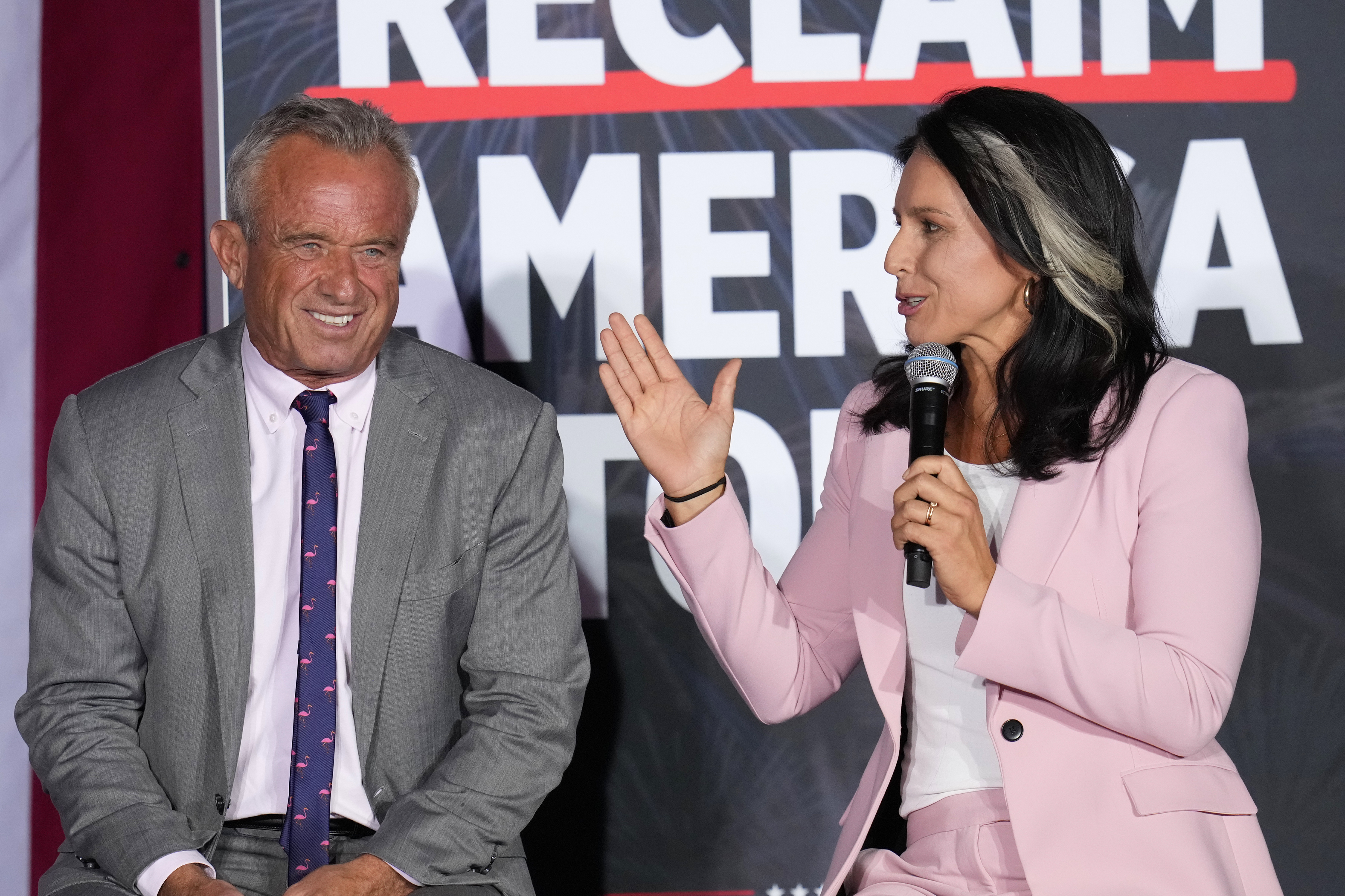 Former Independent candidate for president Robert F. Kennedy, Jr., left, and former Democratic Rep. Tulsi Gabbard speak at a campaign event for Republican presidential nominee former President Donald Trump, Saturday, Sept. 14, 2024, in Glendale, Ariz. (AP Photo/Ross D. Franklin)