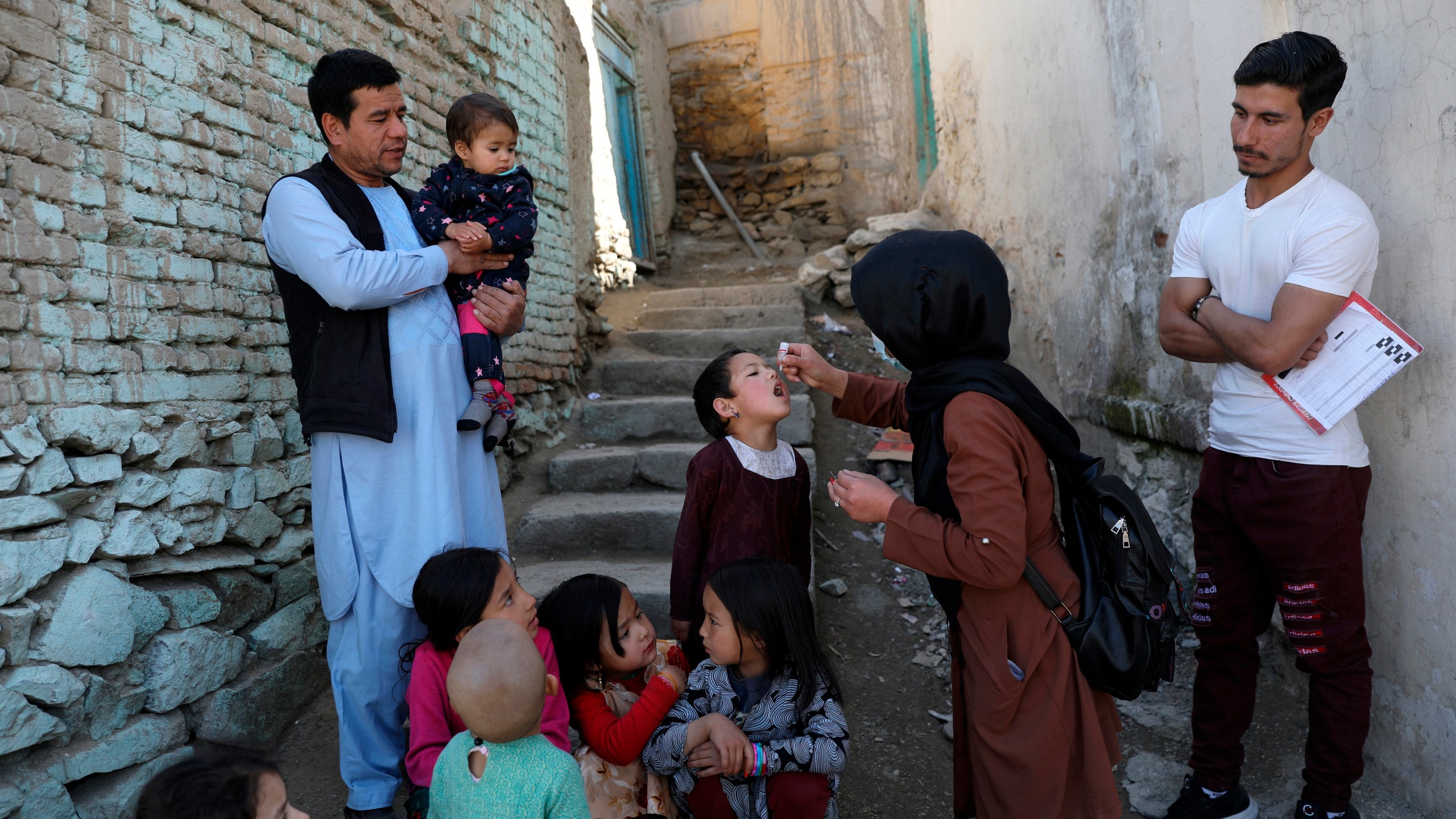 FILE - Shabana Maani, gives a polio vaccination to a child in the old part of Kabul, Afghanistan, Monday, March 29, 2021. (AP Photo/Rahmat Gul, File)