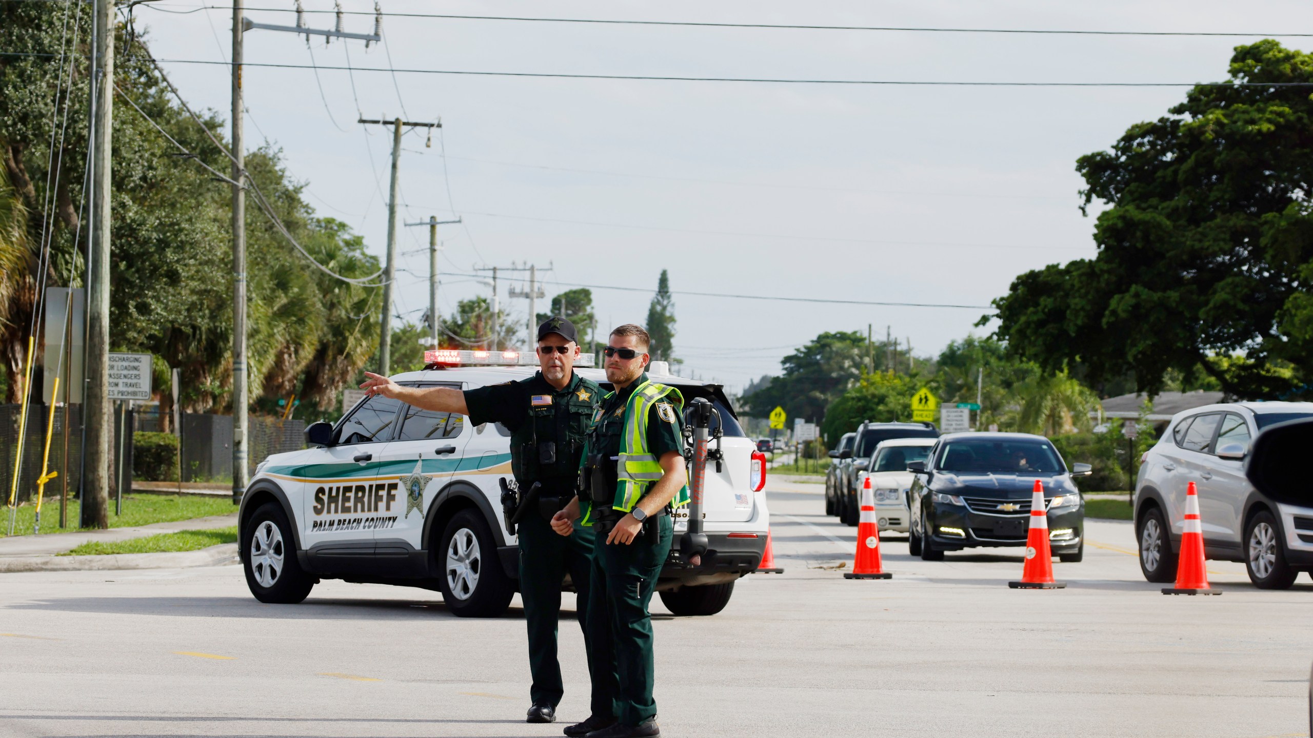 Police officers direct traffic near Trump International Golf Club after the apparent assassination attempt of Republican presidential nominee former President Donald Trump in West Palm Beach, Fla., Sunday, Sept. 15, 2024. (AP Photo/Terry Renna)