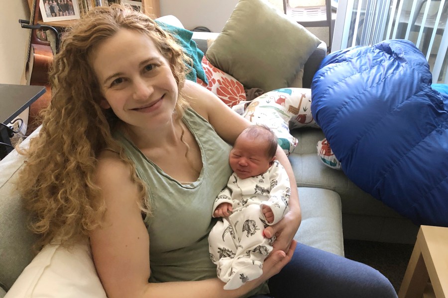 In this photo provided by Liz Chrastil, a neuroscientist with the University of California, Irvine, she her holds her newborn son in May 2020. (Courtesy Liz Chrastil via AP)