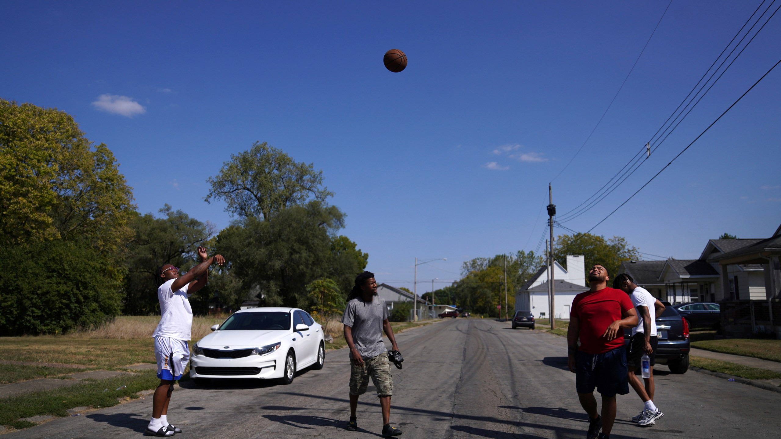 Springfield native Jaheim Almon, left, plays basketball with a group of neighbors in Springfield, Ohio, Monday, Sept. 16, 2024. (AP Photo/Jessie Wardarski)