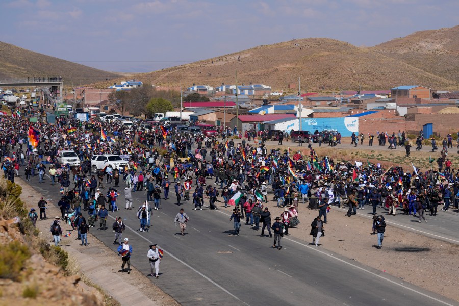 Supporters of former President Evo Morales, who are marching to the capital to protest the government of current President Luis Arce, walk toward Arce supporters who met them along the route in Vila Vila, Bolivia, Tuesday, Sept. 17, 2024. (AP Photo/Juan Karita)