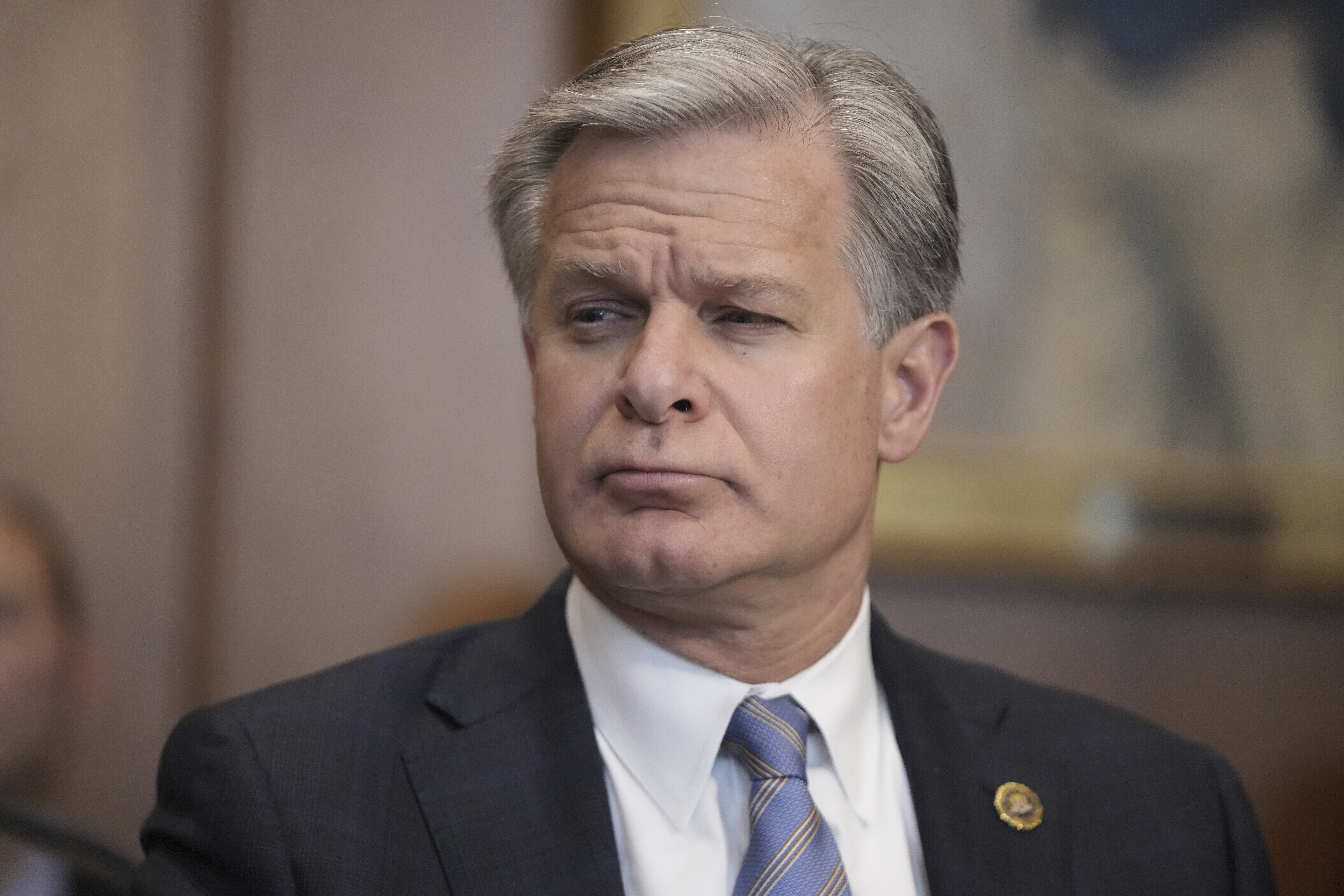 FBI Director Christopher Wray listens during a meeting of the Justice Department's Election Threats Task Force at the Department of Justice, Wednesday, Sept. 4, 2024, in Washington. (AP Photo/Mark Schiefelbein)