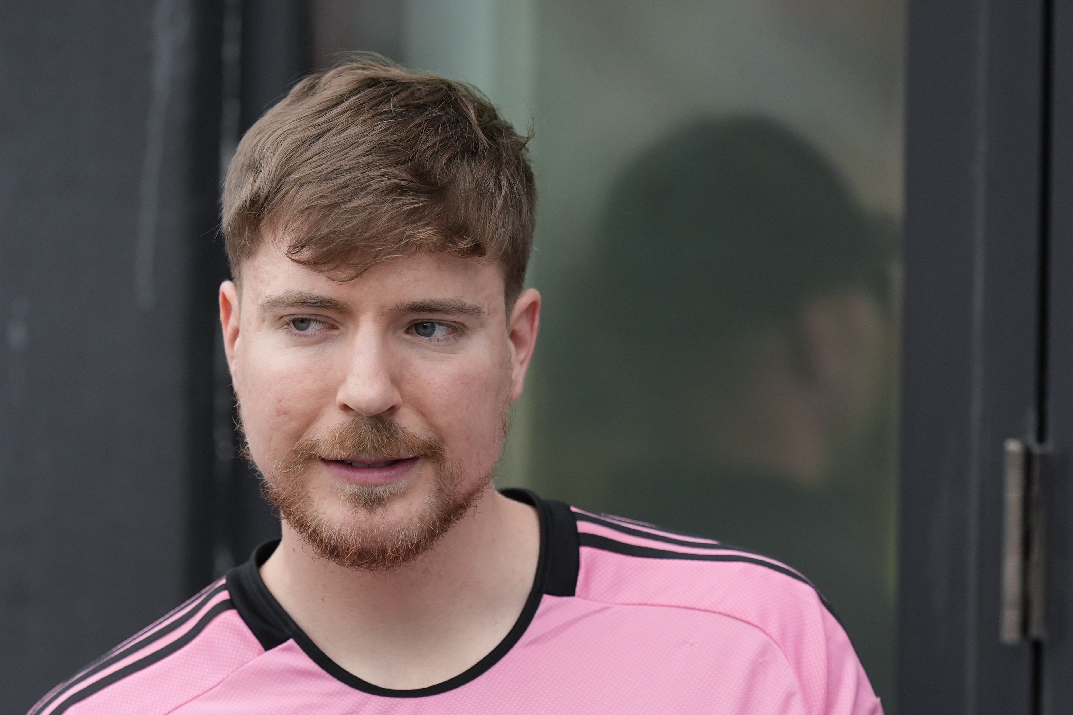 FILE - Jimmy Donaldson, the popular YouTube video maker who goes by MrBeast, wears a Lionel Messi jersey as he stands in a sideline box at the start of an MLS soccer match between Inter Miami and CF Montreal Sunday, March 10, 2024, in Fort Lauderdale, Fla. (AP Photo/Rebecca Blackwell, File)